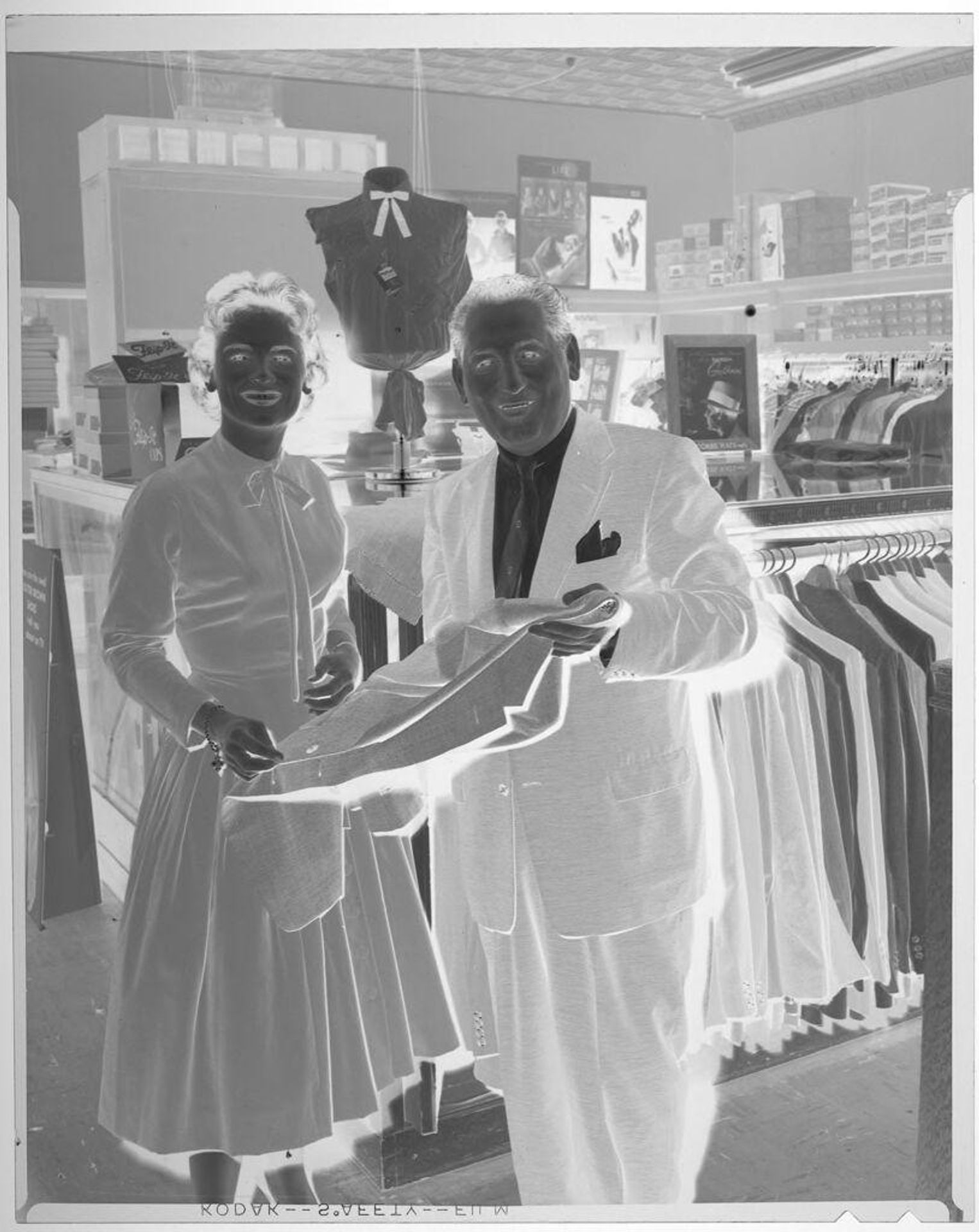 Untitled (Miss Wool and Sam Glosserman, Mayor in clothing store) by Harry Annas