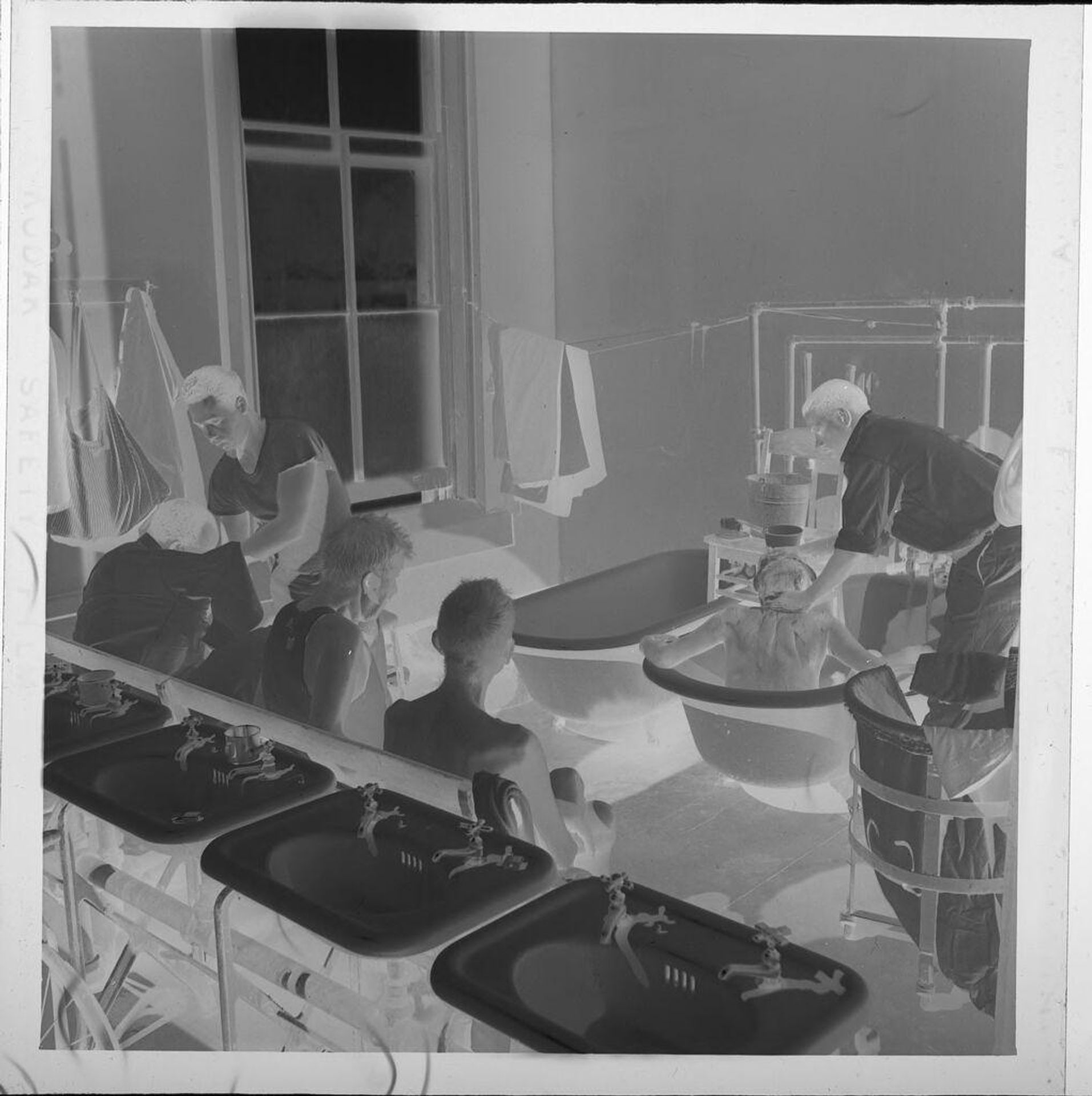 Untitled (boys next to bathtubs and sinks) by Jack Gould