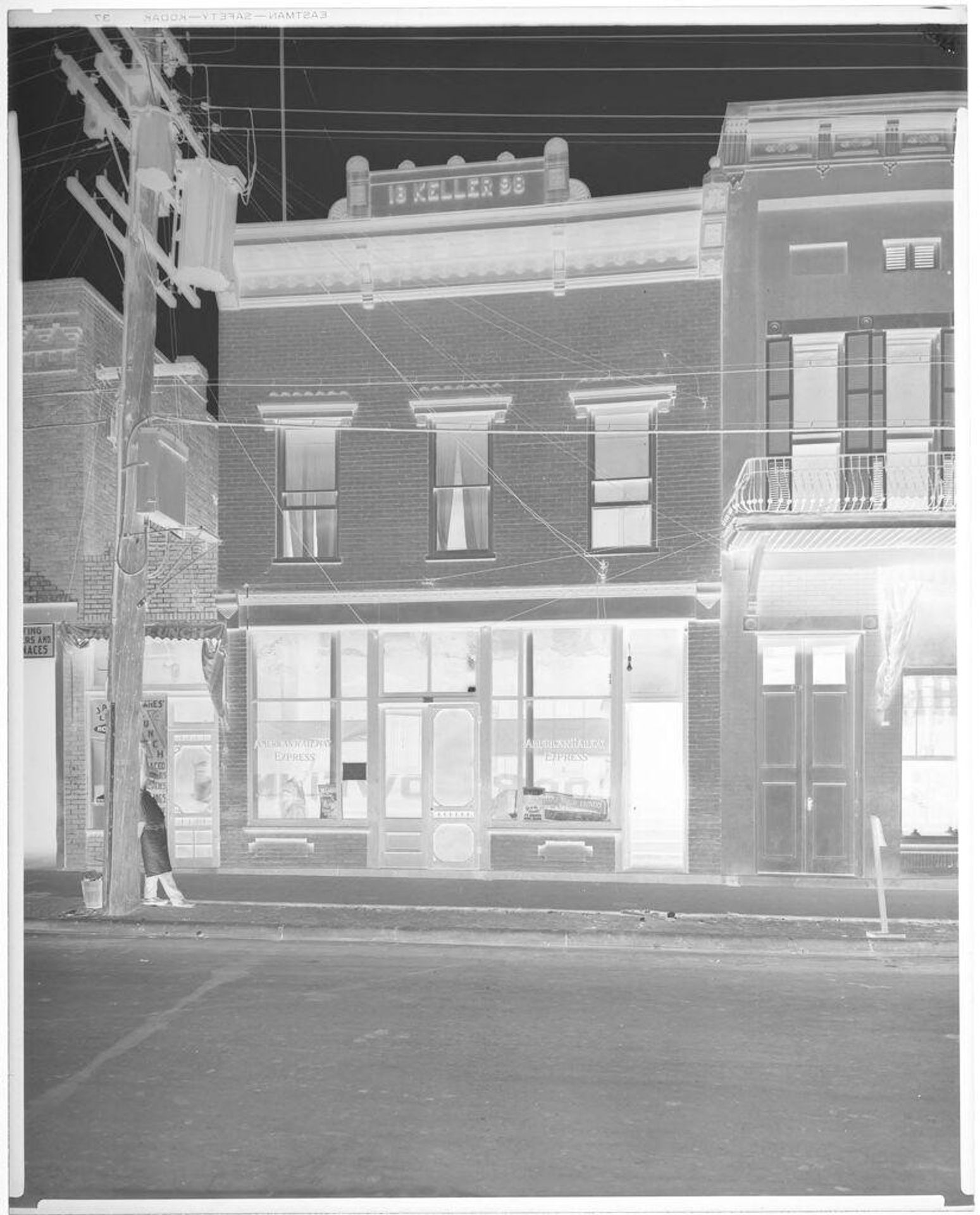 Untitled (man standing outside American Railway Express) by Hamblin Studio