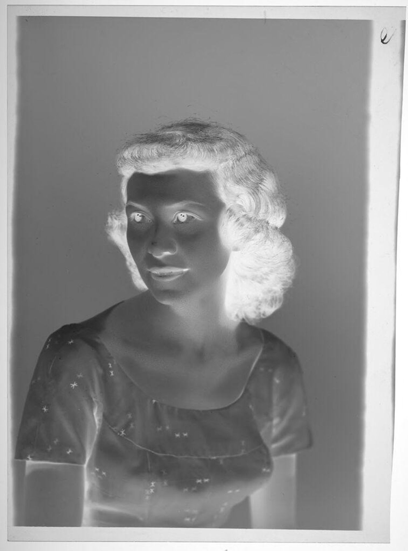 Untitled (studio portrait of young woman with dark wavy hair and white dress) by Martin Schweig