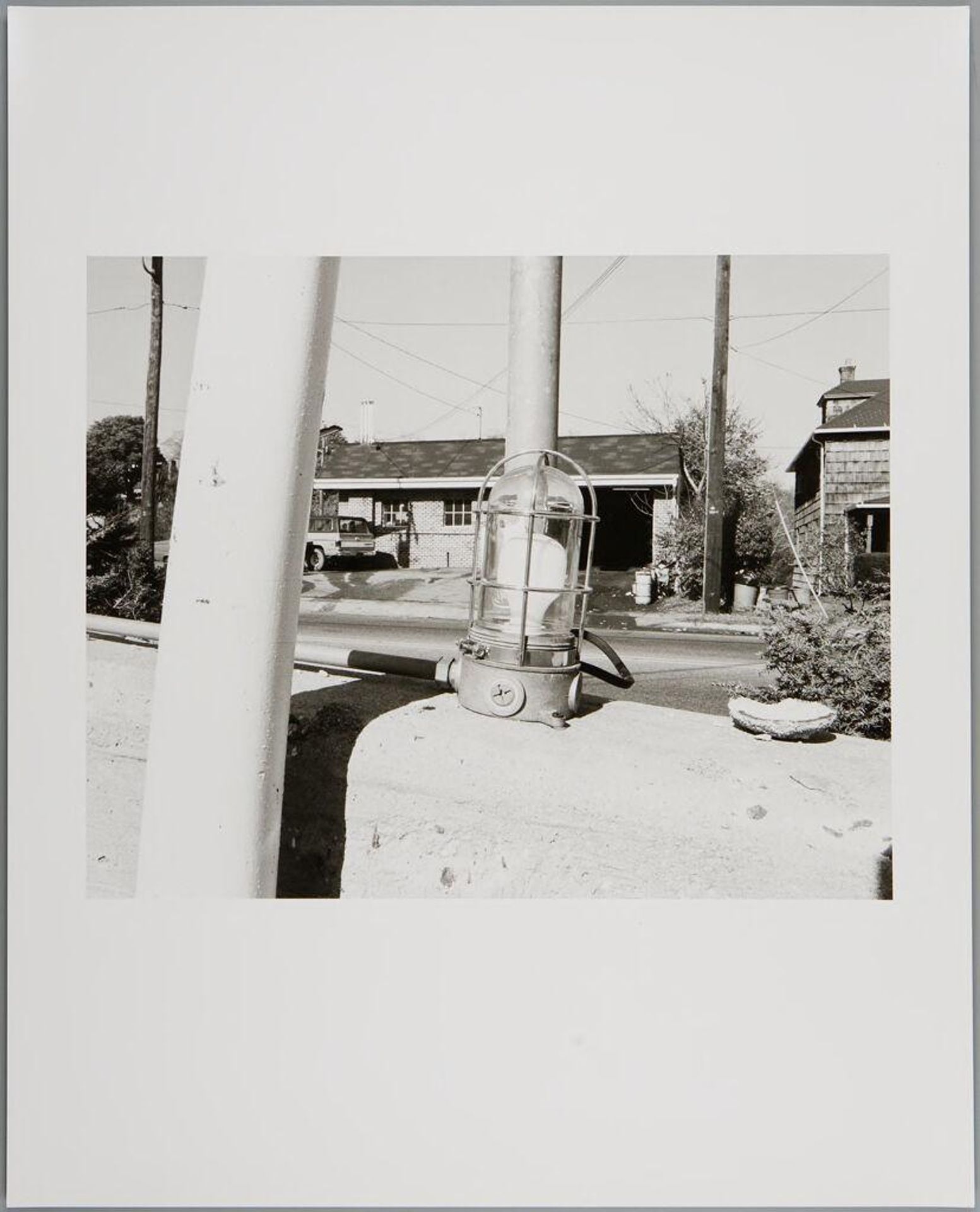 Untitled (emergency light on barrier in front of house) by John Gossage