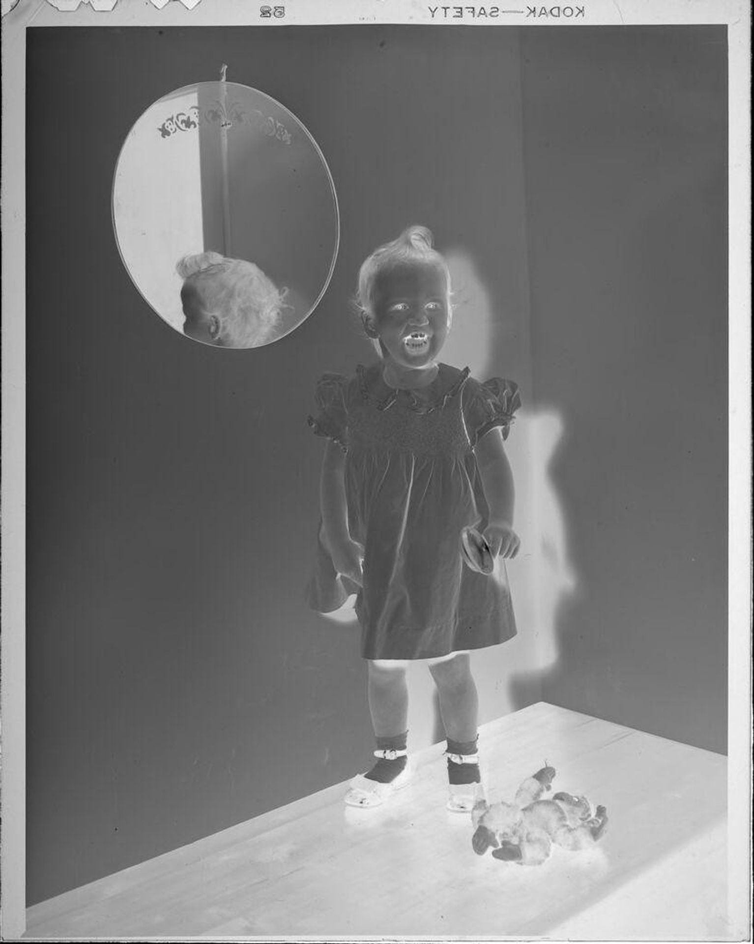 Untitled (little girl next to mirror) by Lucian and Mary Brown