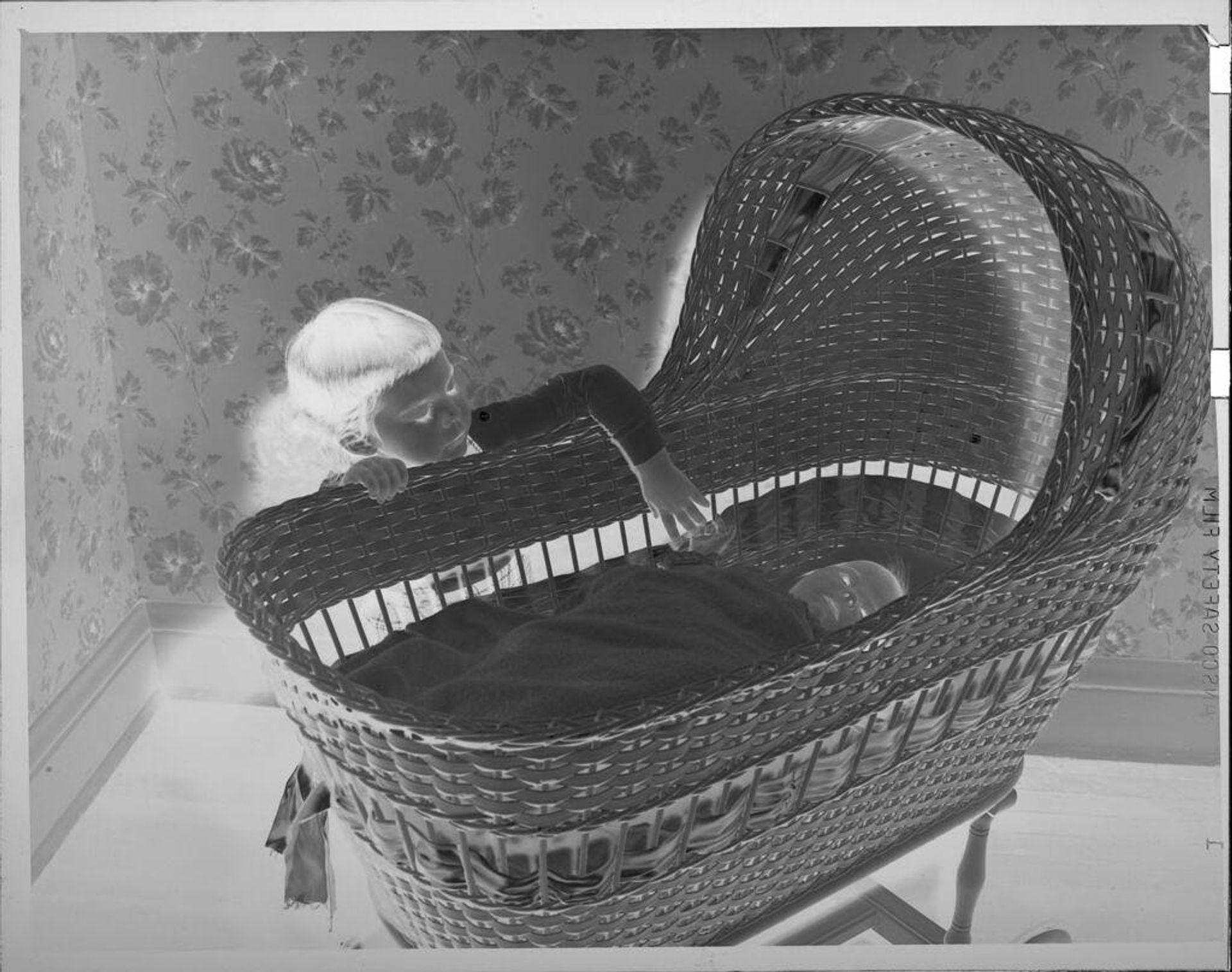 Untitled (girl with baby in bassinet) by Lucian and Mary Brown