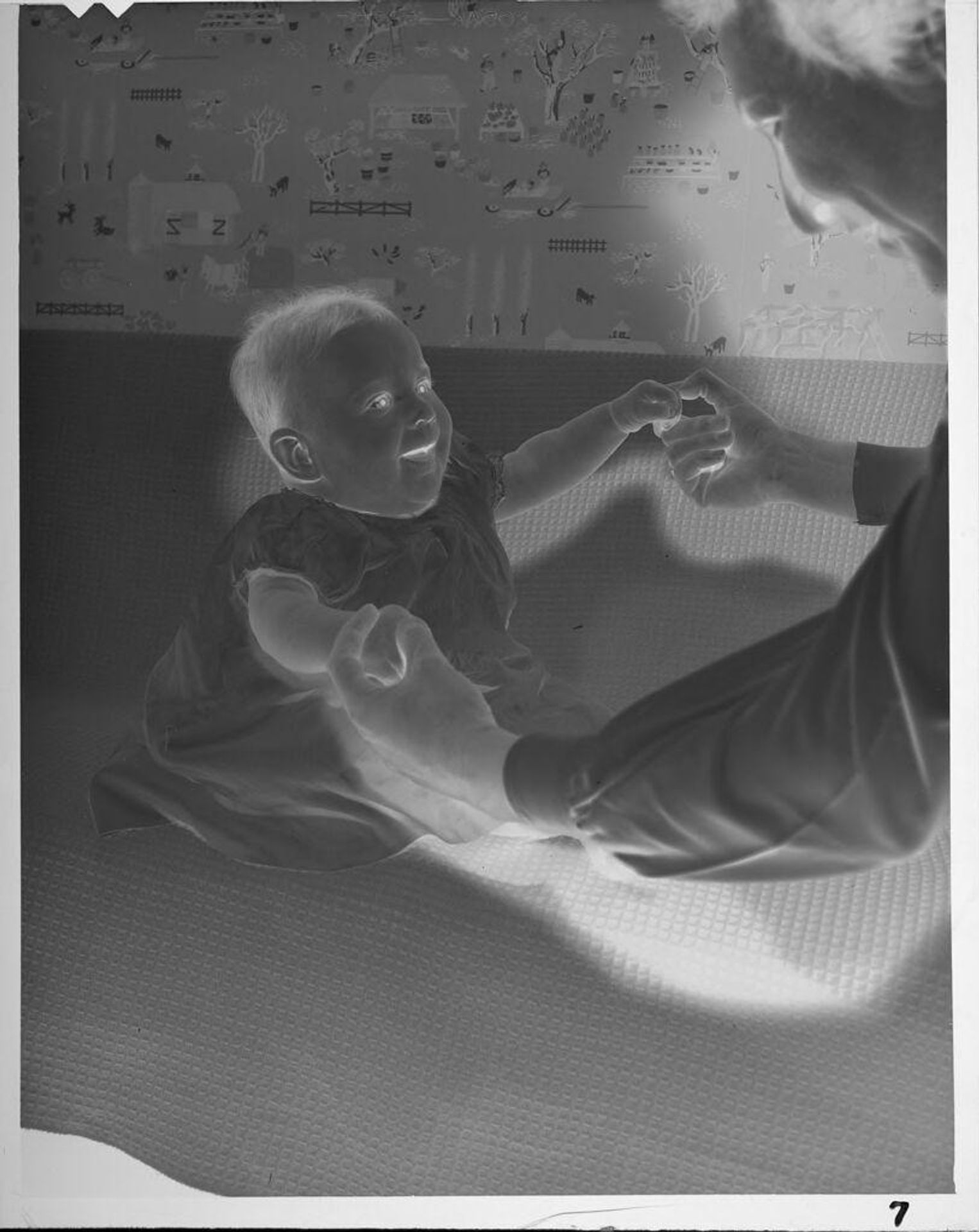 Untitled (woman holding baby's hands) by Lucian and Mary Brown
