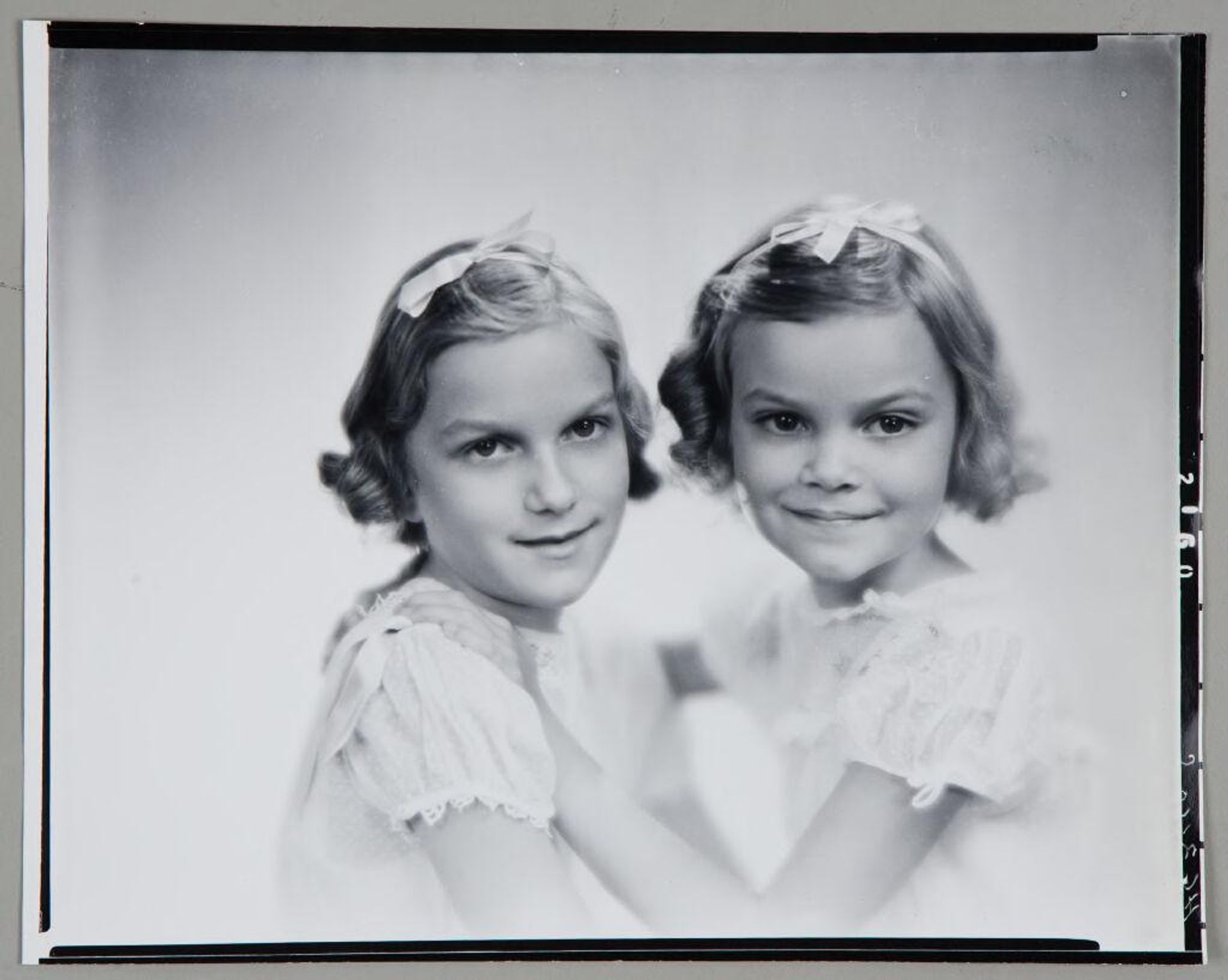 Untitled (portrait of two girls with matching dresses and bows in hair) by Paul Gittings