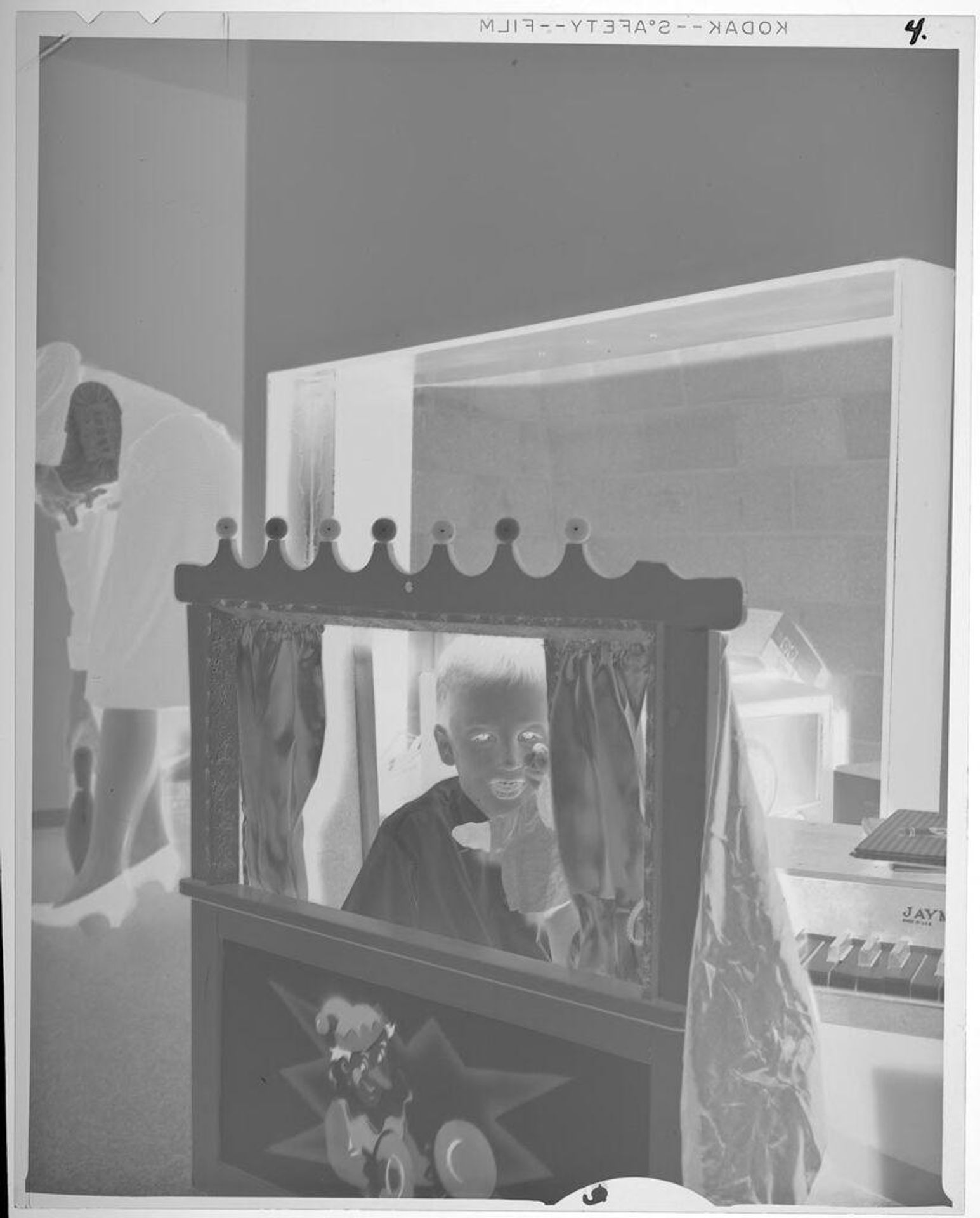 Untitled (boy performing homemade puppet show) by Lucian and Mary Brown