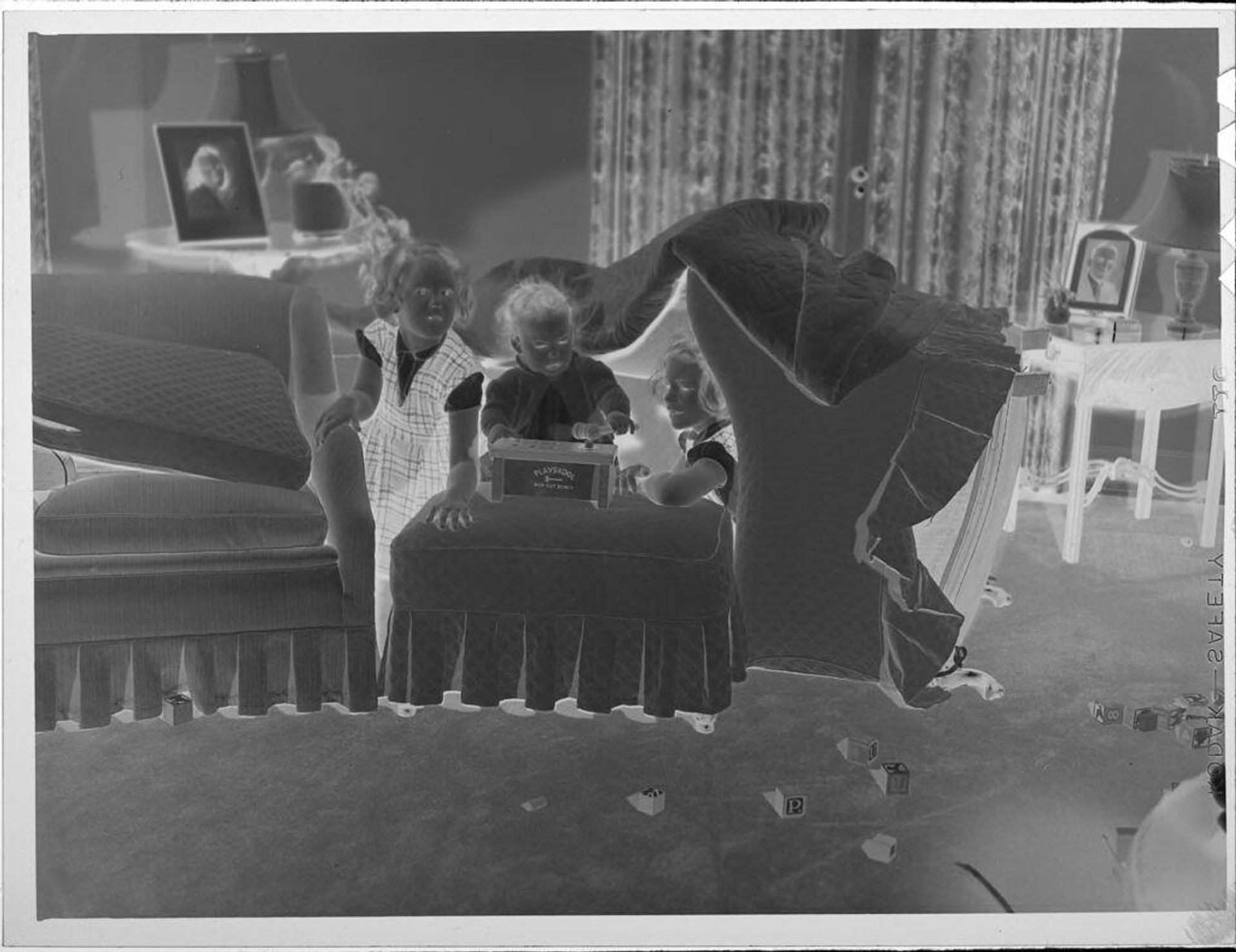 Untitled (three children playing on chairs) by Lucian and Mary Brown