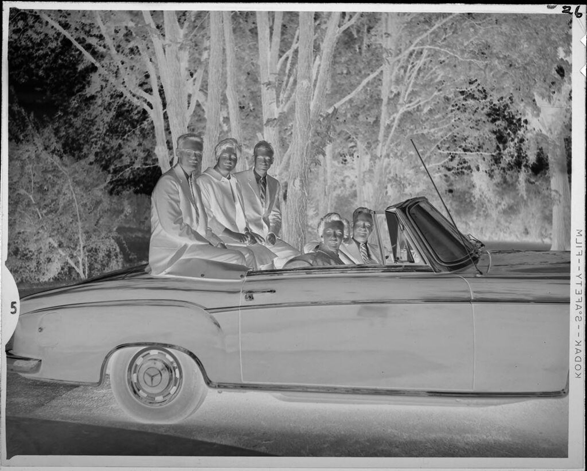 Untitled (adults and children sitting in car) by Lucian and Mary Brown