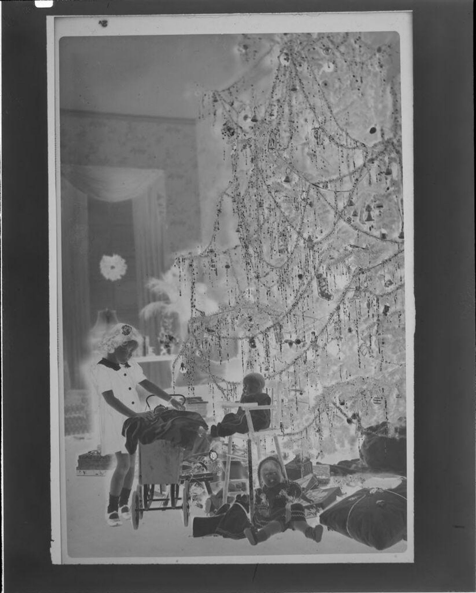 Untitled (Eugenie Stoll in front of Christmas tree) by C. Bennette Moore