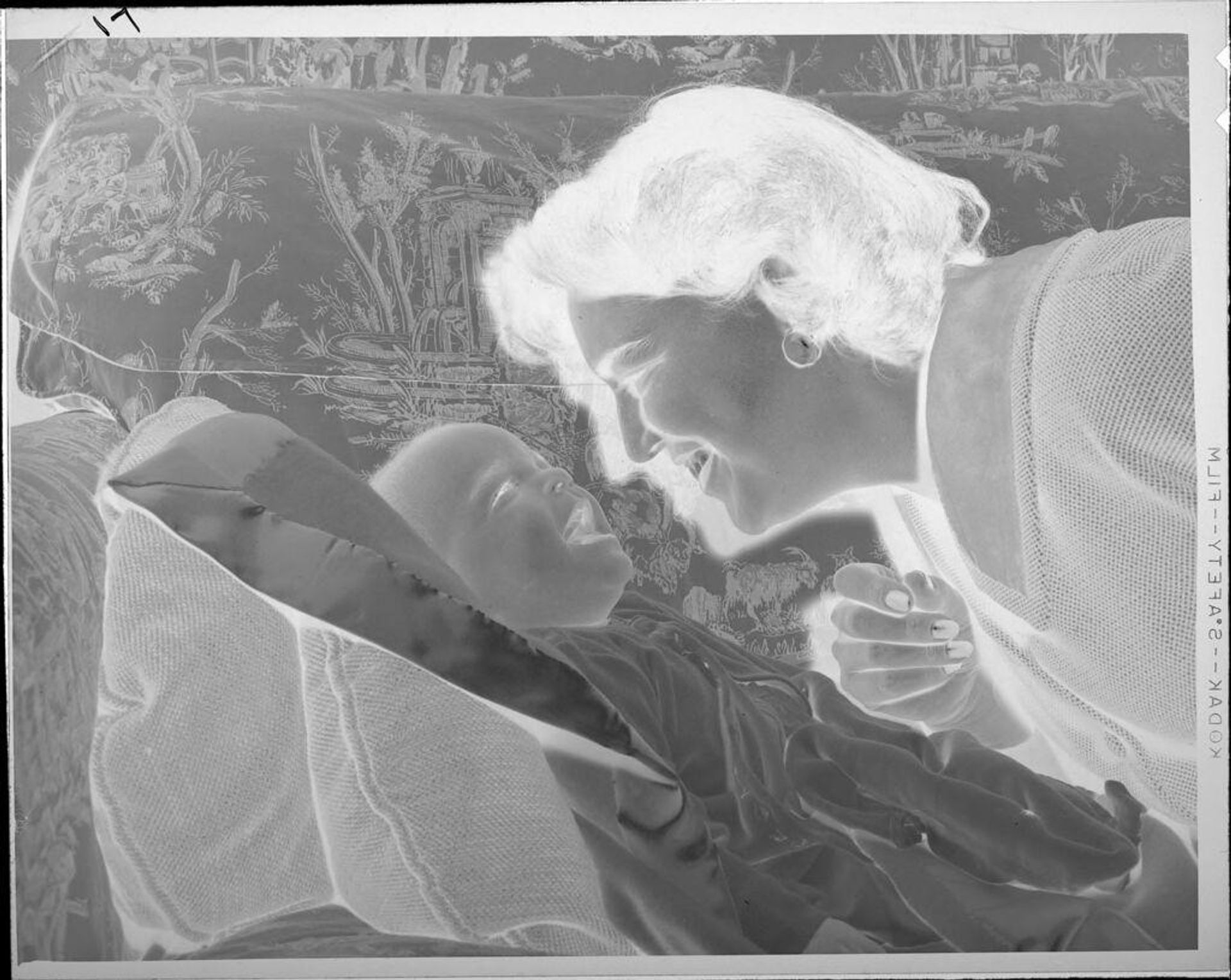 Untitled (woman smiling at baby on couch) by Lucian and Mary Brown