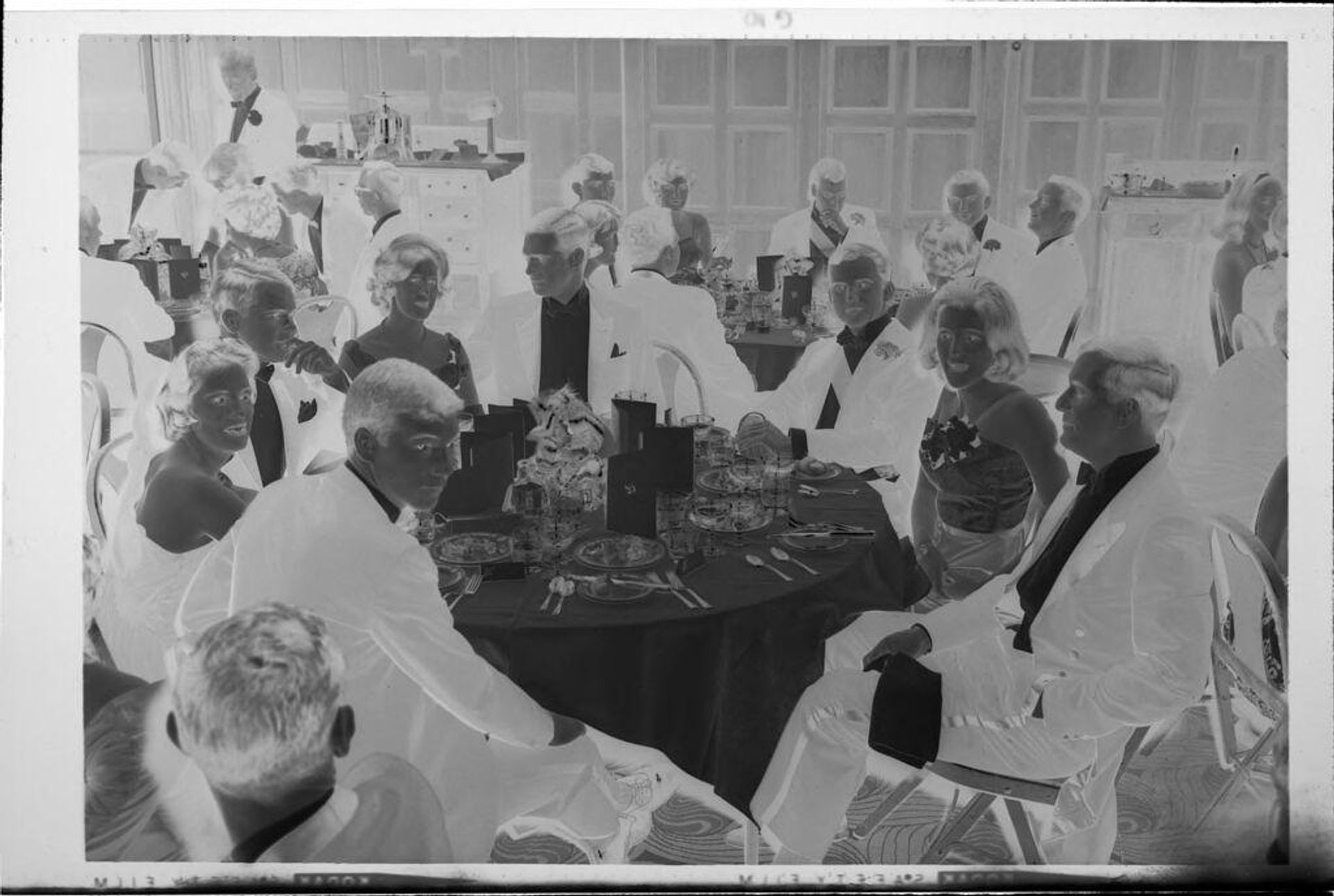 Untitled (young men and woman at tables at ball) by Robert Burian