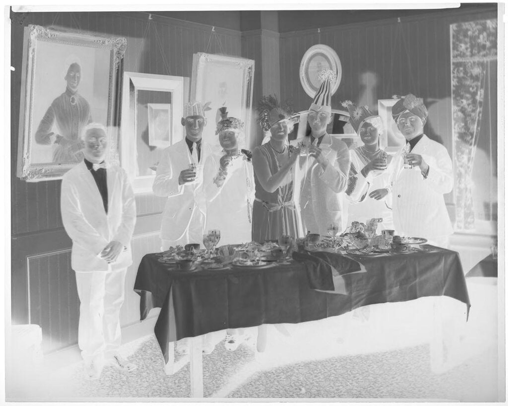 Untitled (group of six in party hats raising a toast) by Hamblin Studio