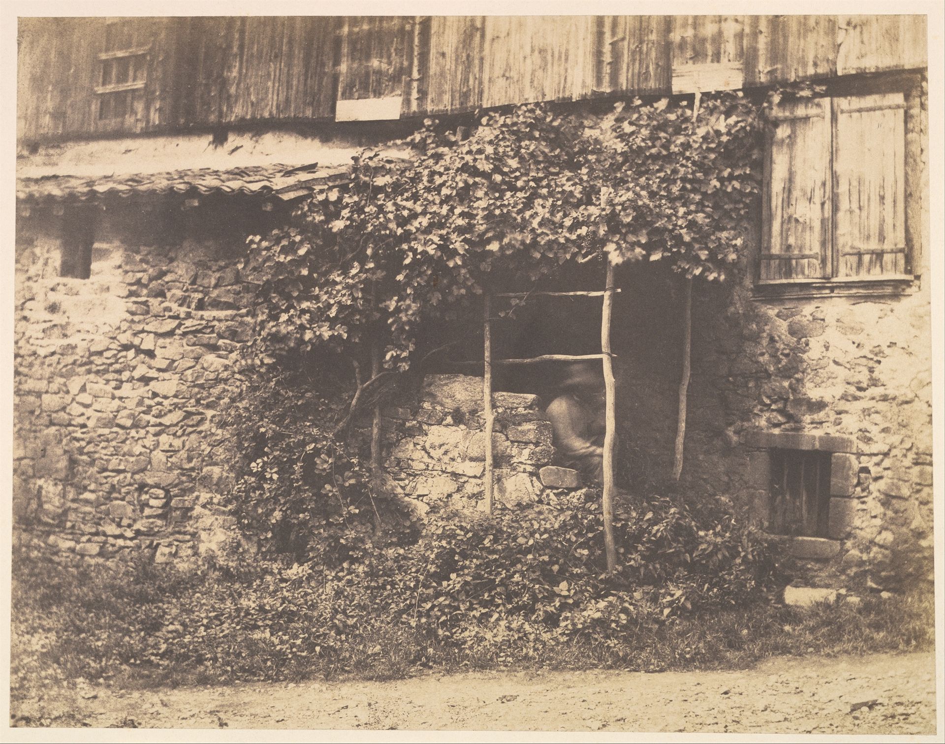 [Rustic Building with Man under Trellis] by André Giroux
