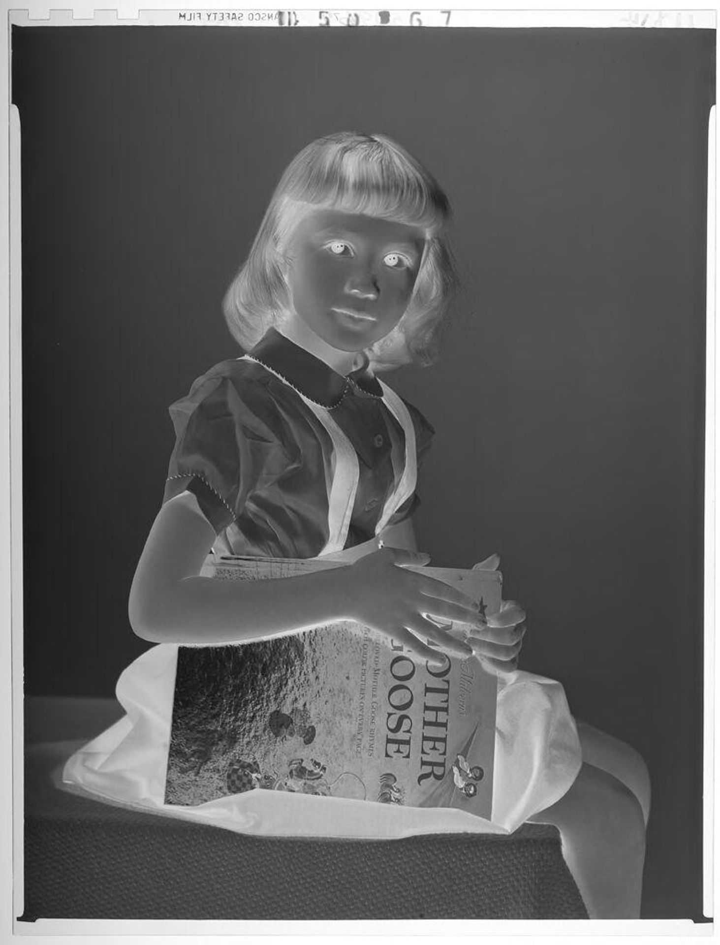Untitled (portrait of little girl with Mother Goose book) by Paul Gittings