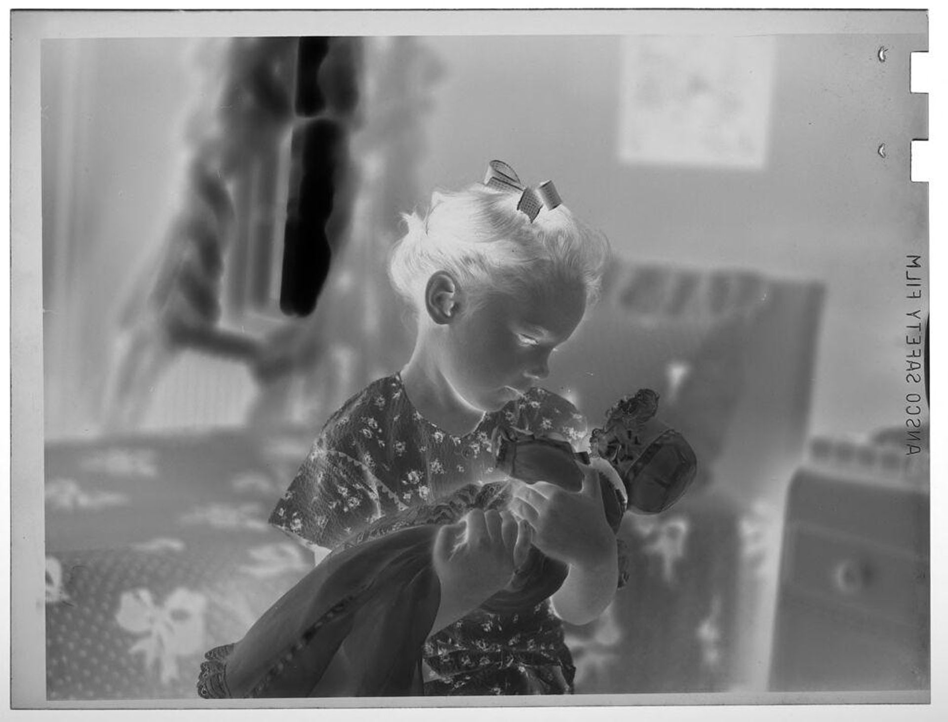 Untitled (girl holding doll) by Lucian and Mary Brown