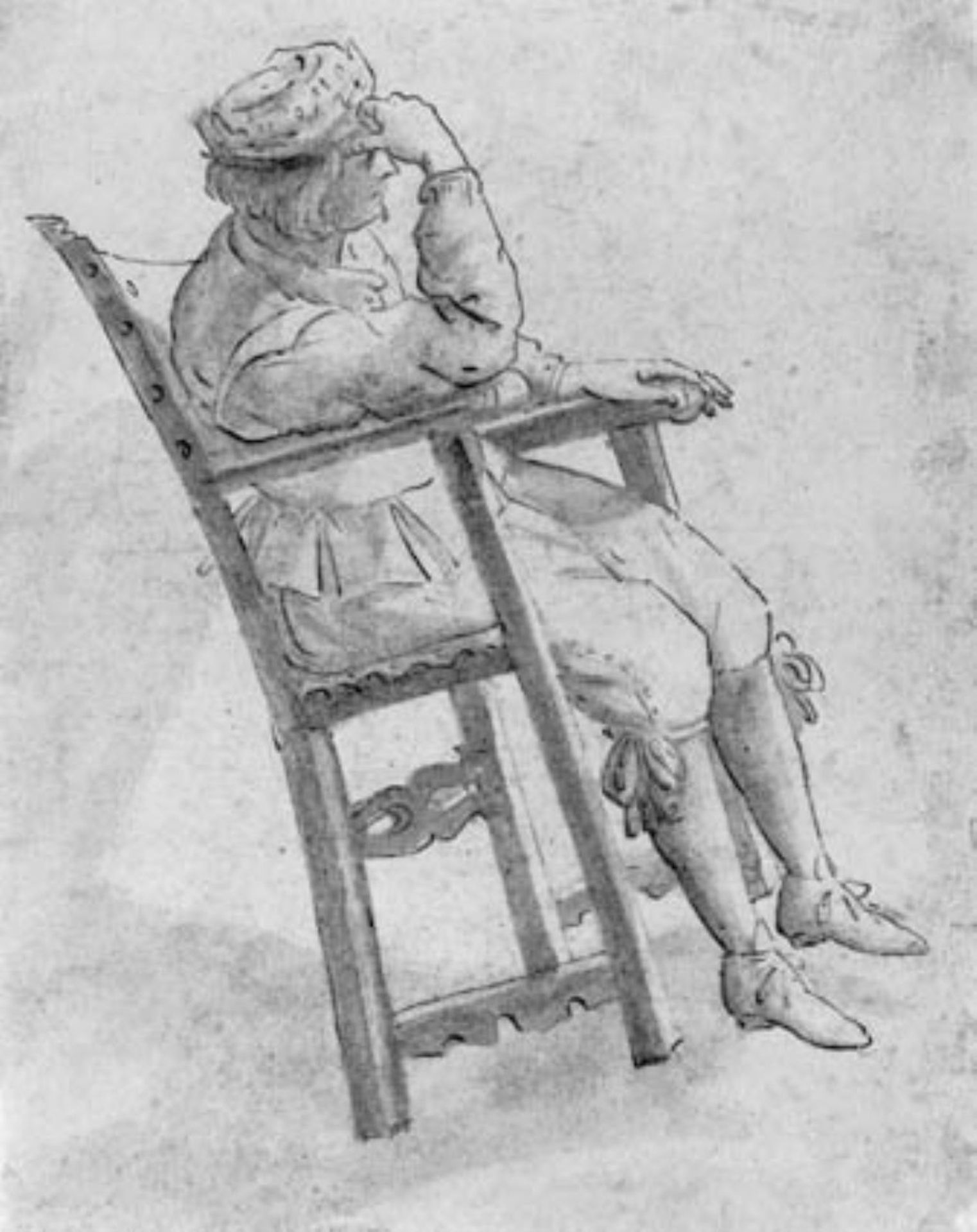 Young man resting his head in his right hand, tilting his chair back by Anonymous
