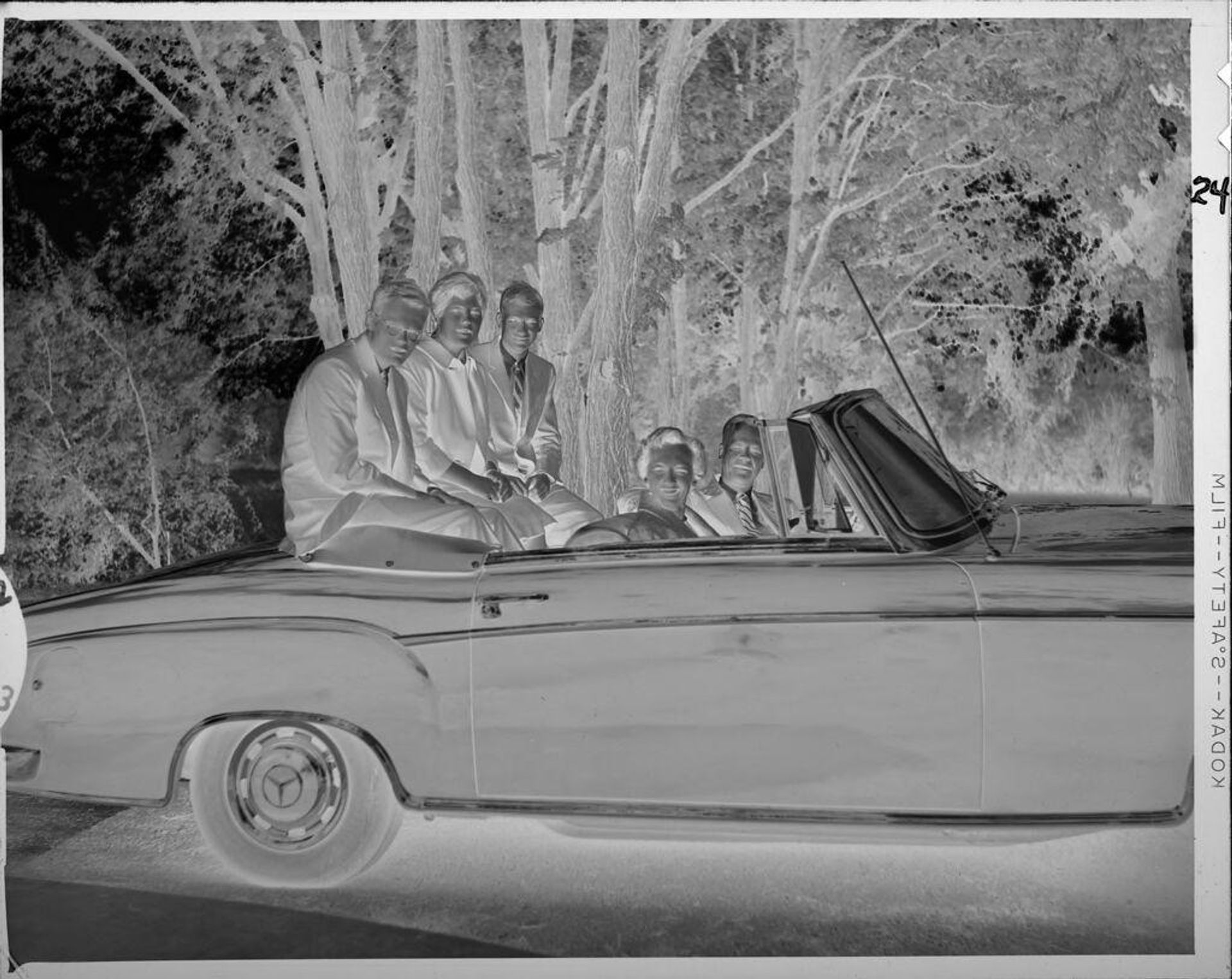 Untitled (family riding in convertible) by Lucian and Mary Brown