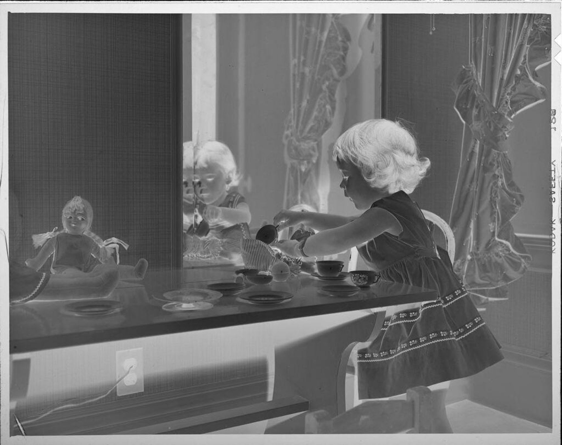 Untitled (little girl having tea party) by Lucian and Mary Brown