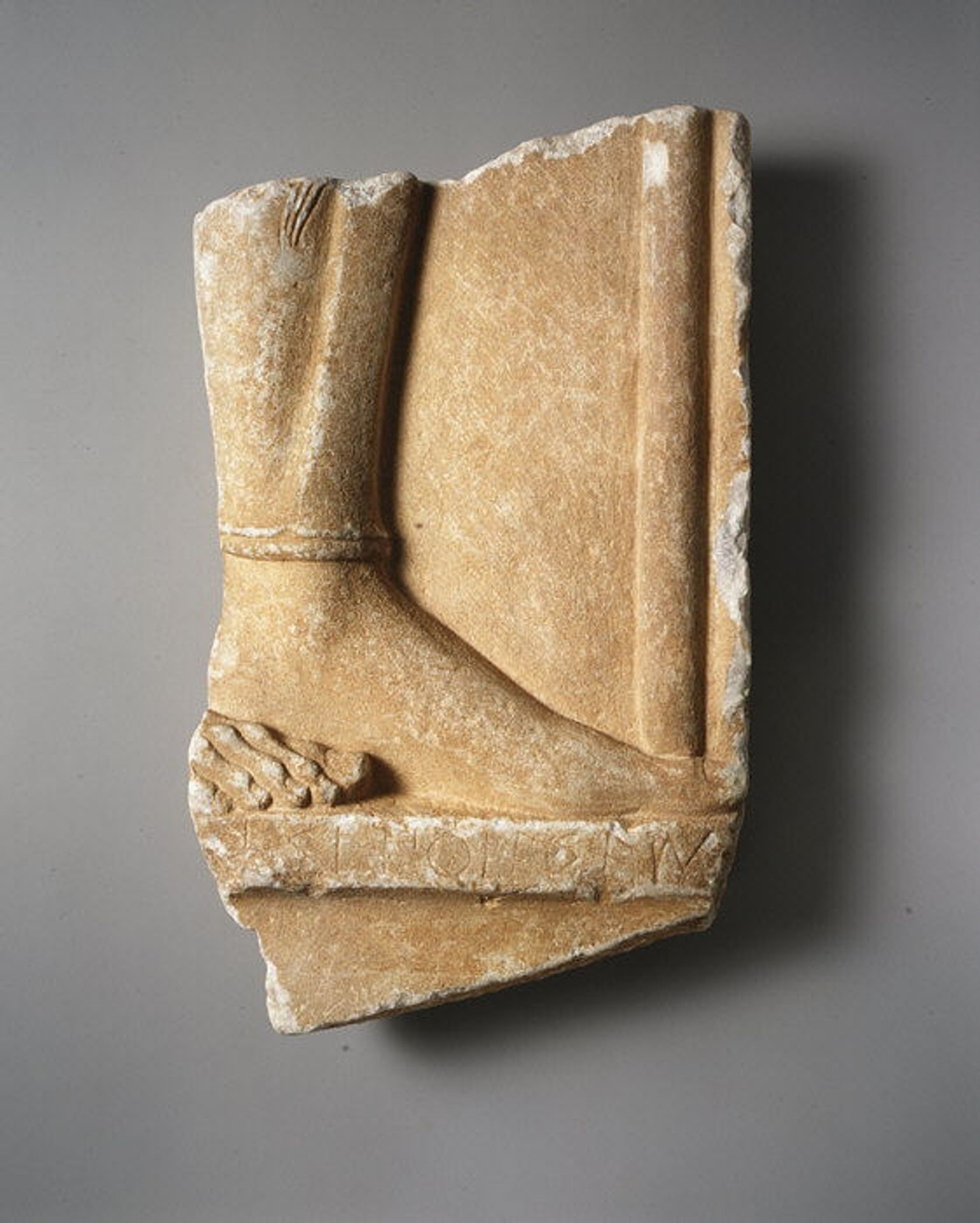 Fragmentary marble grave stele of a hoplite (foot soldier) by Aristokles