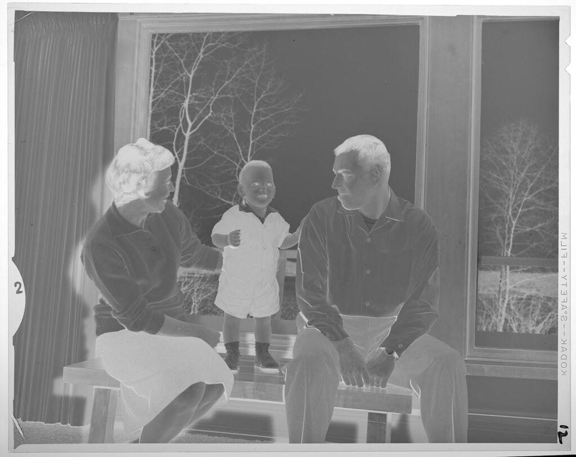 Untitled (man, woman, and baby by window) by Lucian and Mary Brown