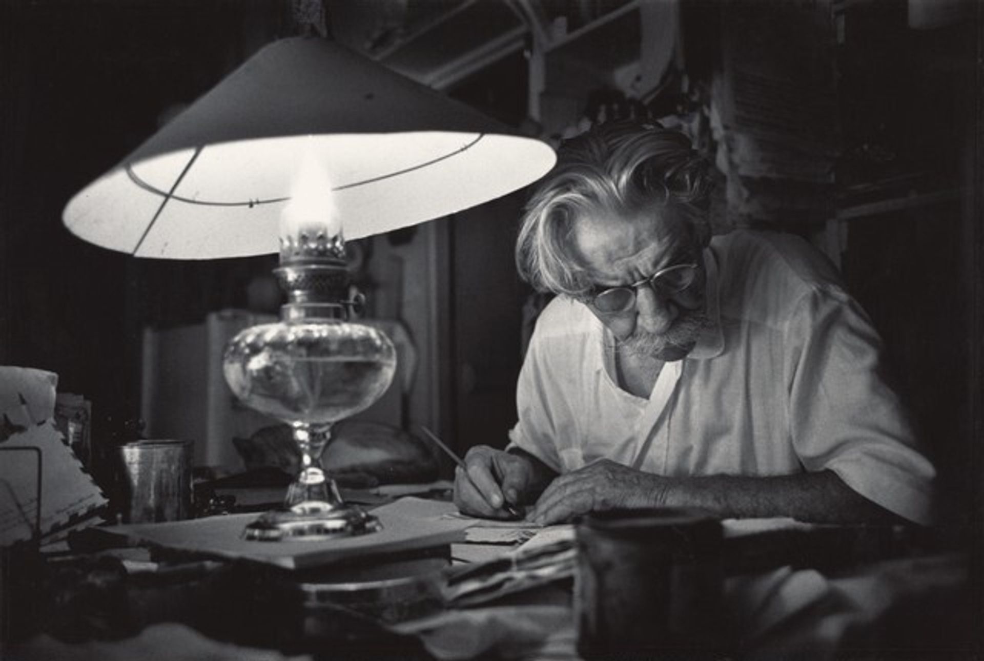 Long after the Hospital Is Asleep, Schweitzer Works at His Desk by W. Eugene Smith