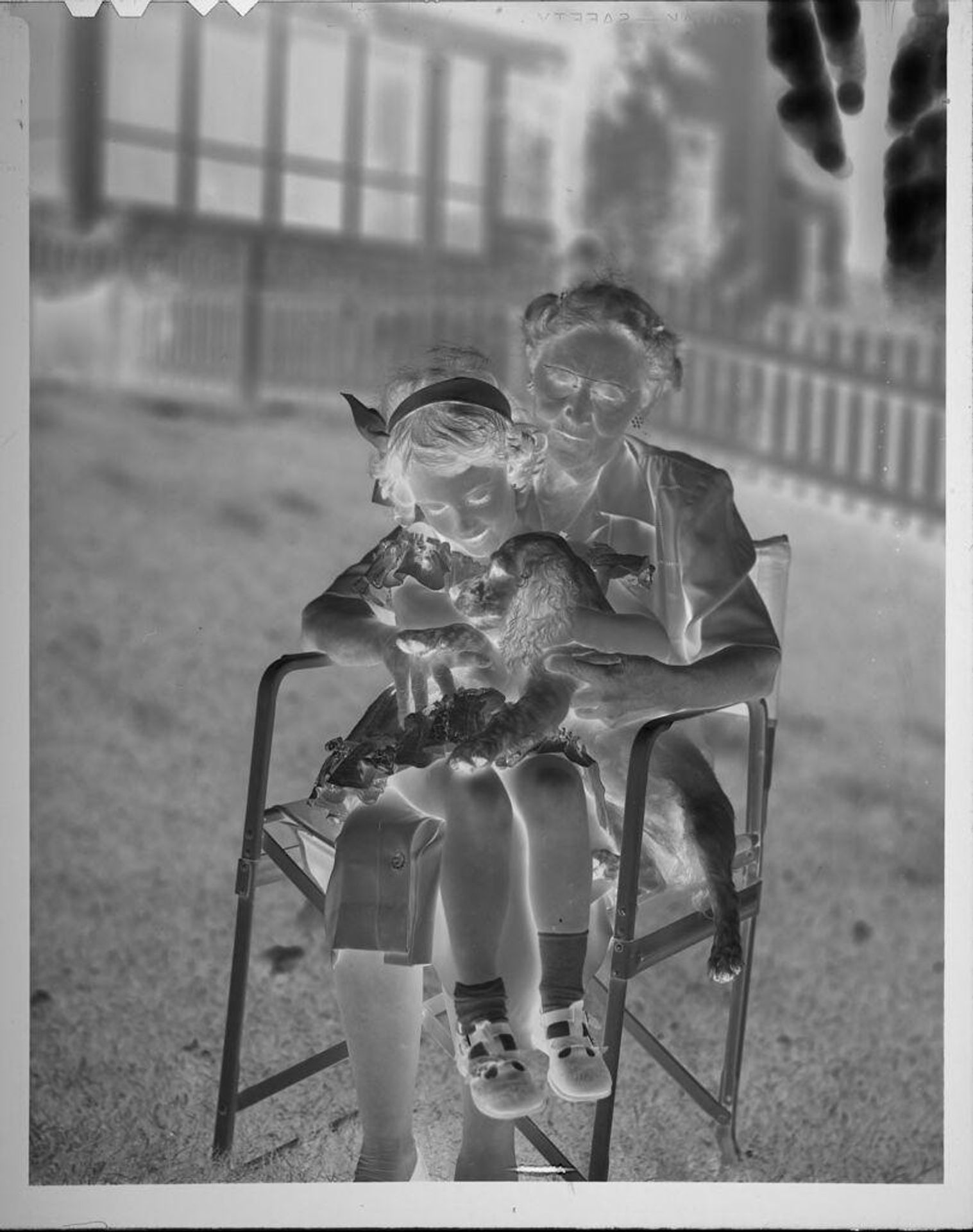 Untitled (woman on chair with granddaughter and dog) by Lucian and Mary Brown