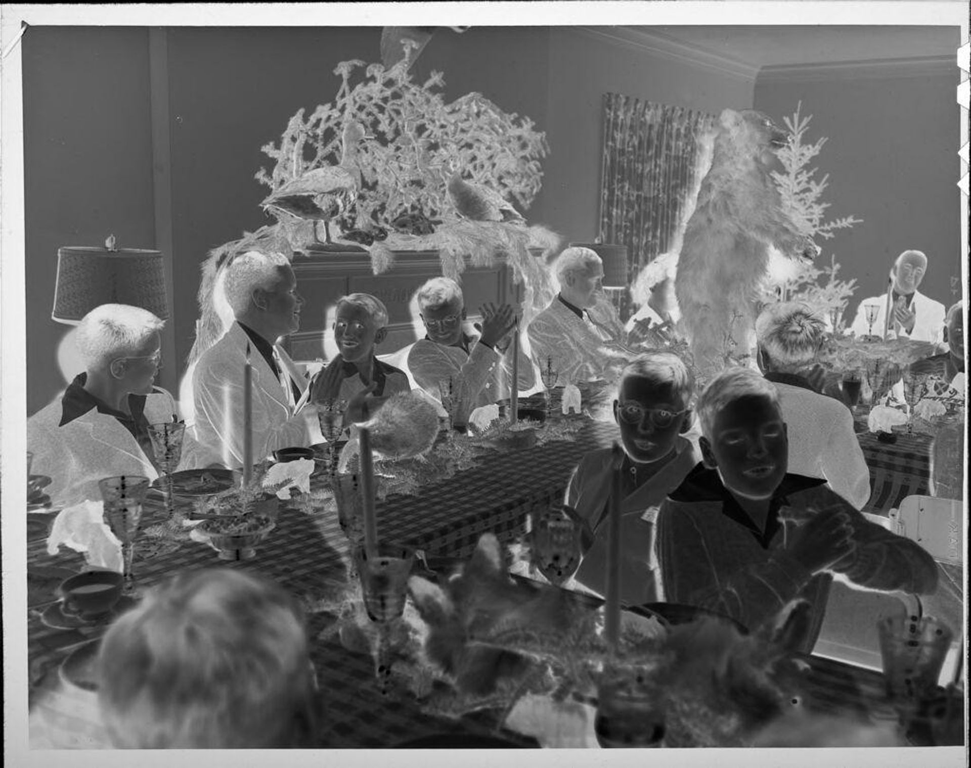 Untitled (people eating at party, large stuffed bear in room) by Lucian and Mary Brown