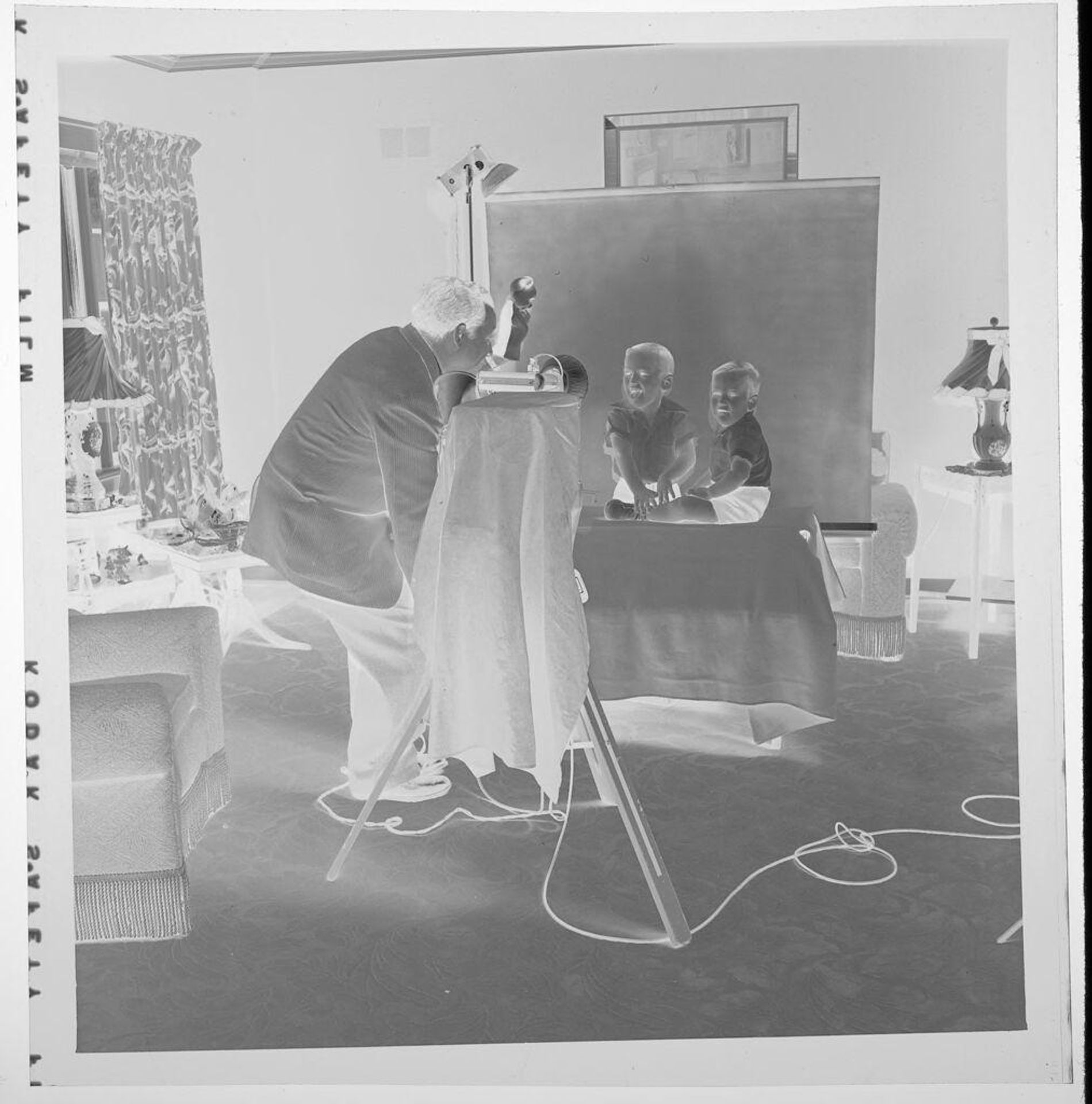 Untitled (photographer taking studio portrait of two boys) by Jack Gould