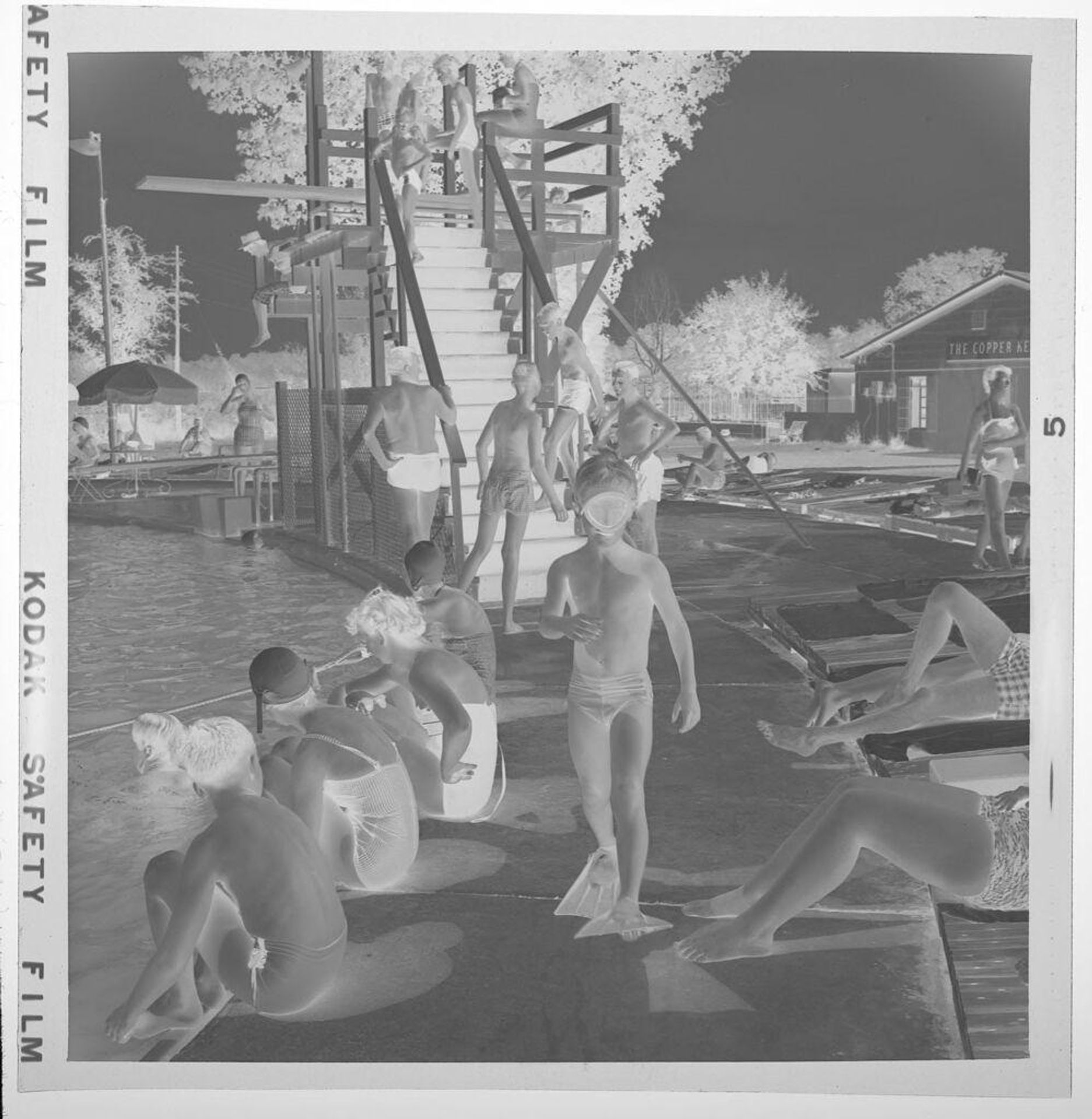 Untitled (children in swimming attire on deck by pool) by Jack Gould