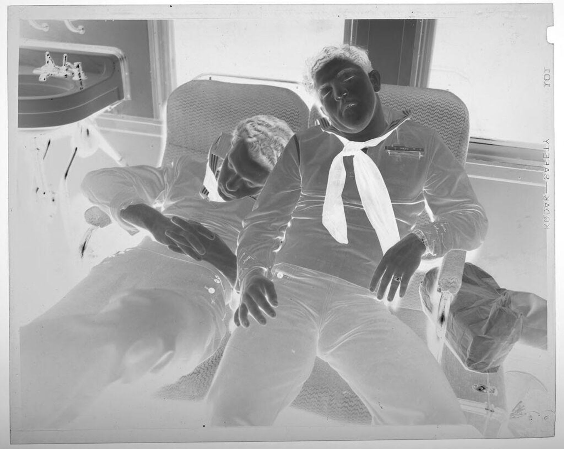 Untitled (two young men sleeping on train seats) by Jack Gould