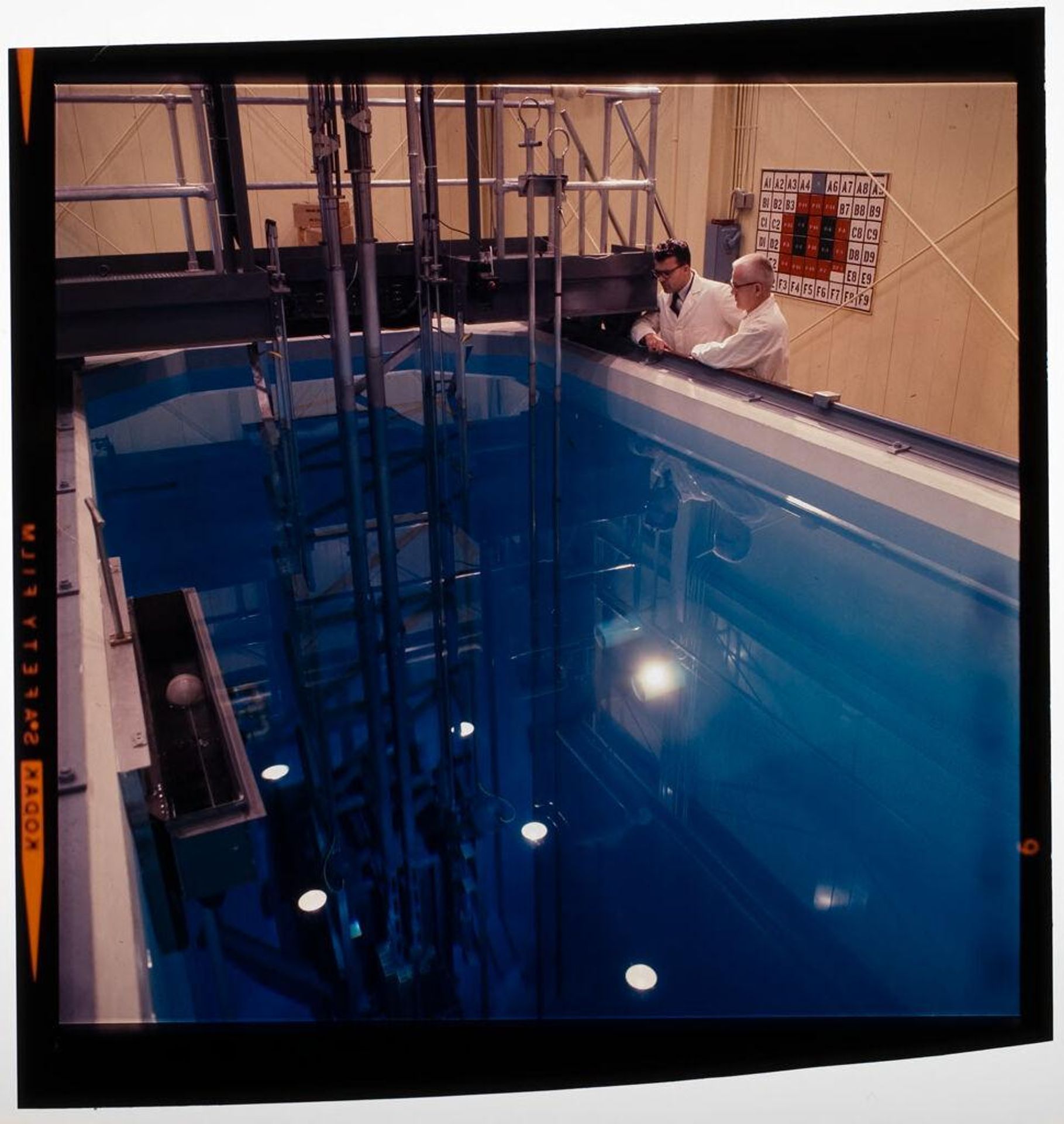 Untitled (scientists looking into pool of water at research facility) by Jack Gould
