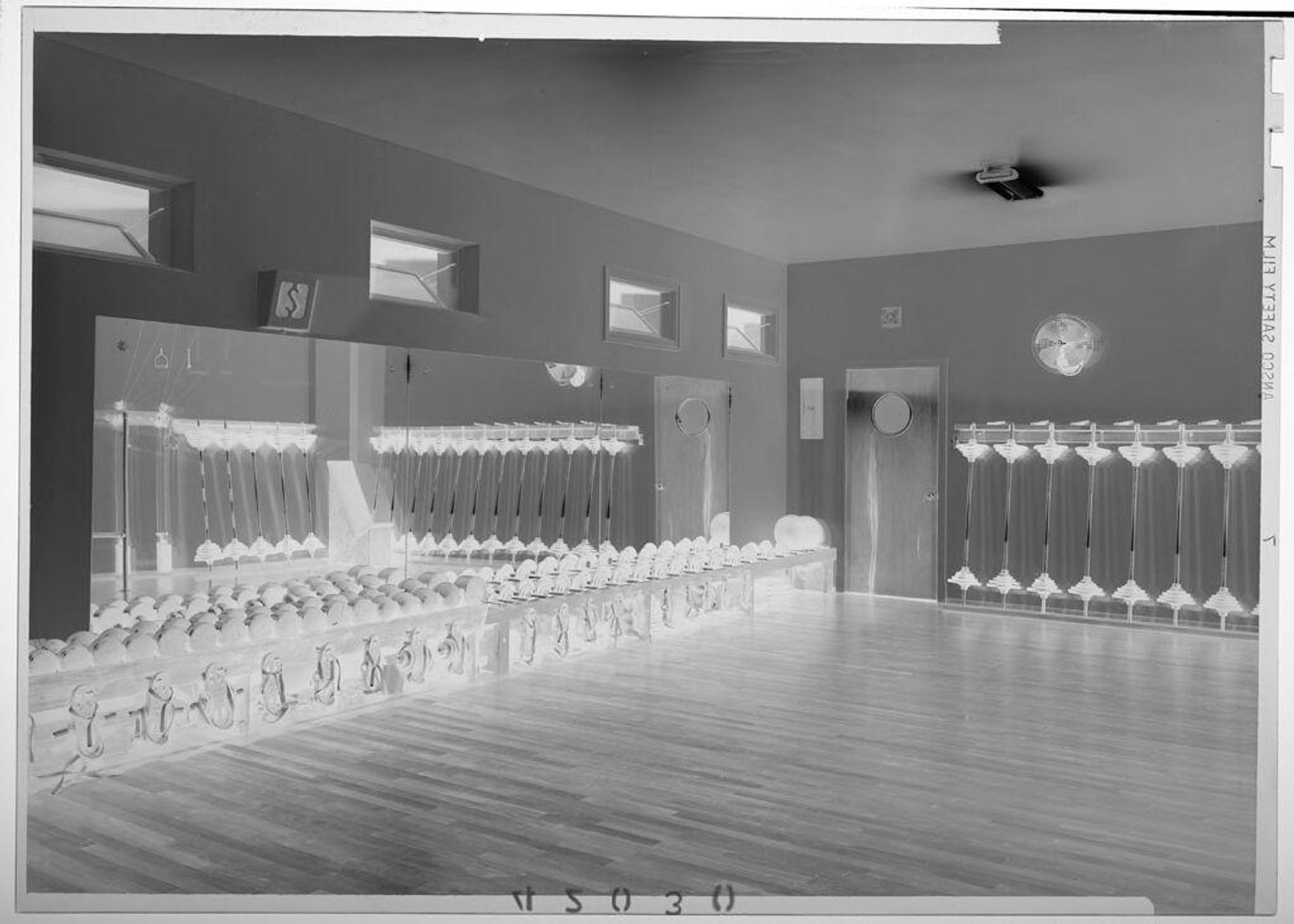 Untitled (interior view of weight room with mirrors on one wall) by Martin Schweig