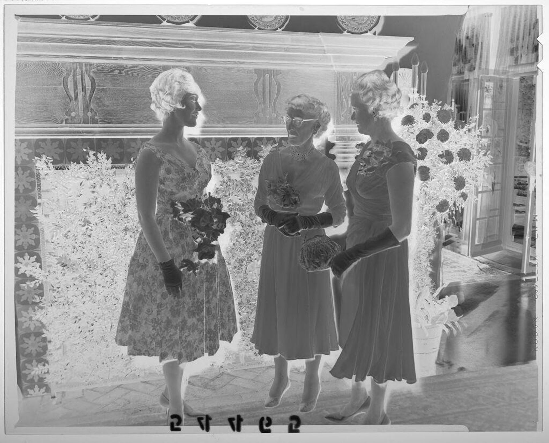 Untitled (young woman chatting with mother and grandmother at debutante party) by Martin Schweig