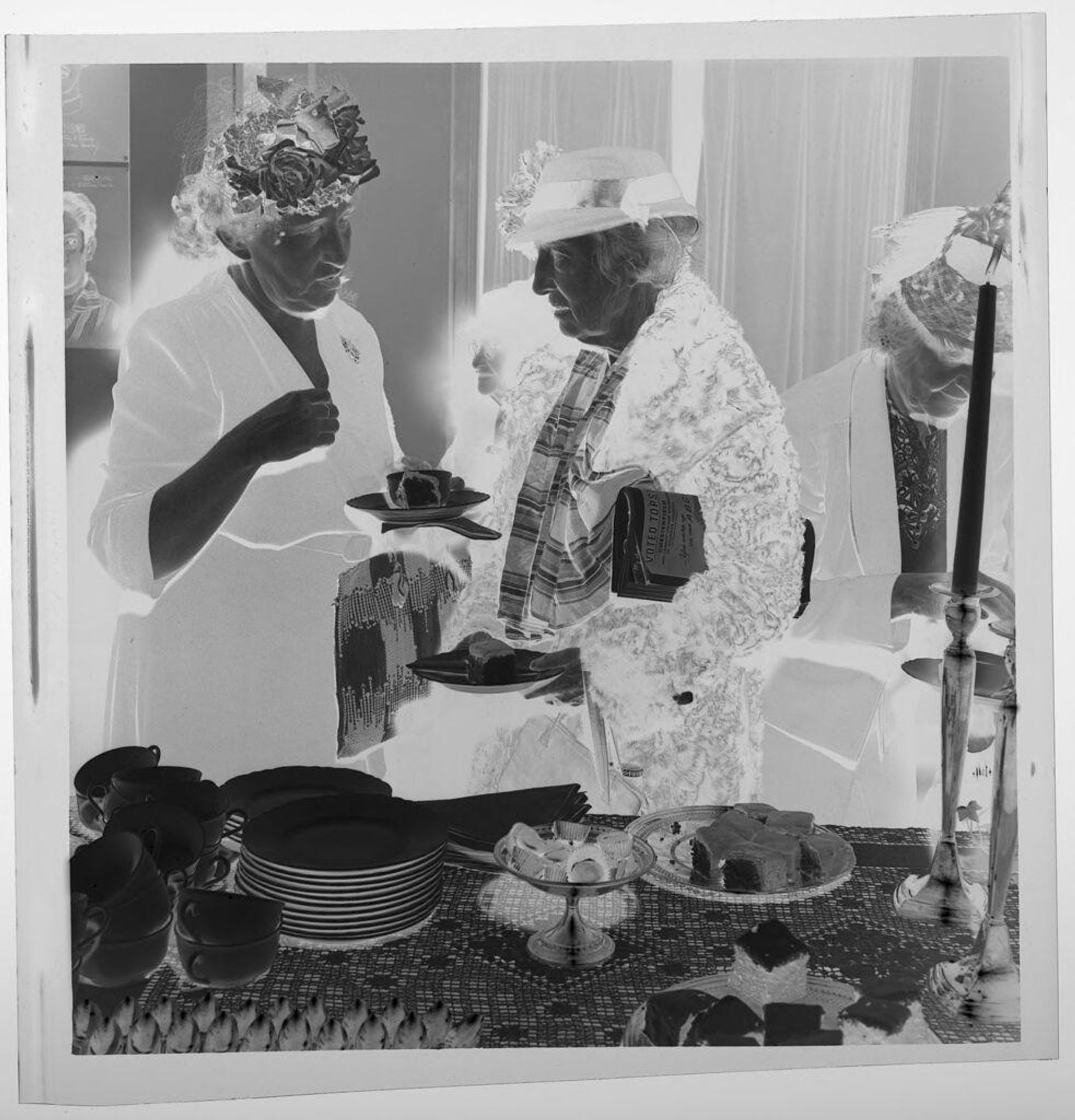 Untitled (elderly women wearing hats taking desserts from buffet table) by Jack Gould