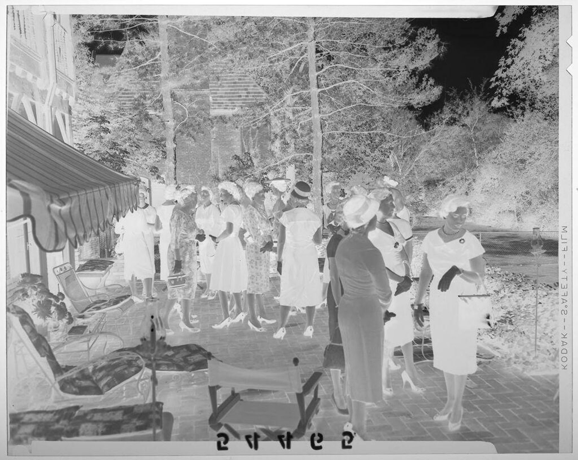 Untitled (women standing around outdoor patio at debutante party) by Martin Schweig