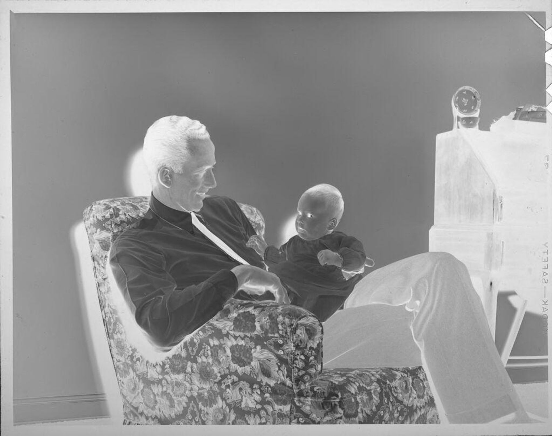 Untitled (man holding baby) by Lucian and Mary Brown