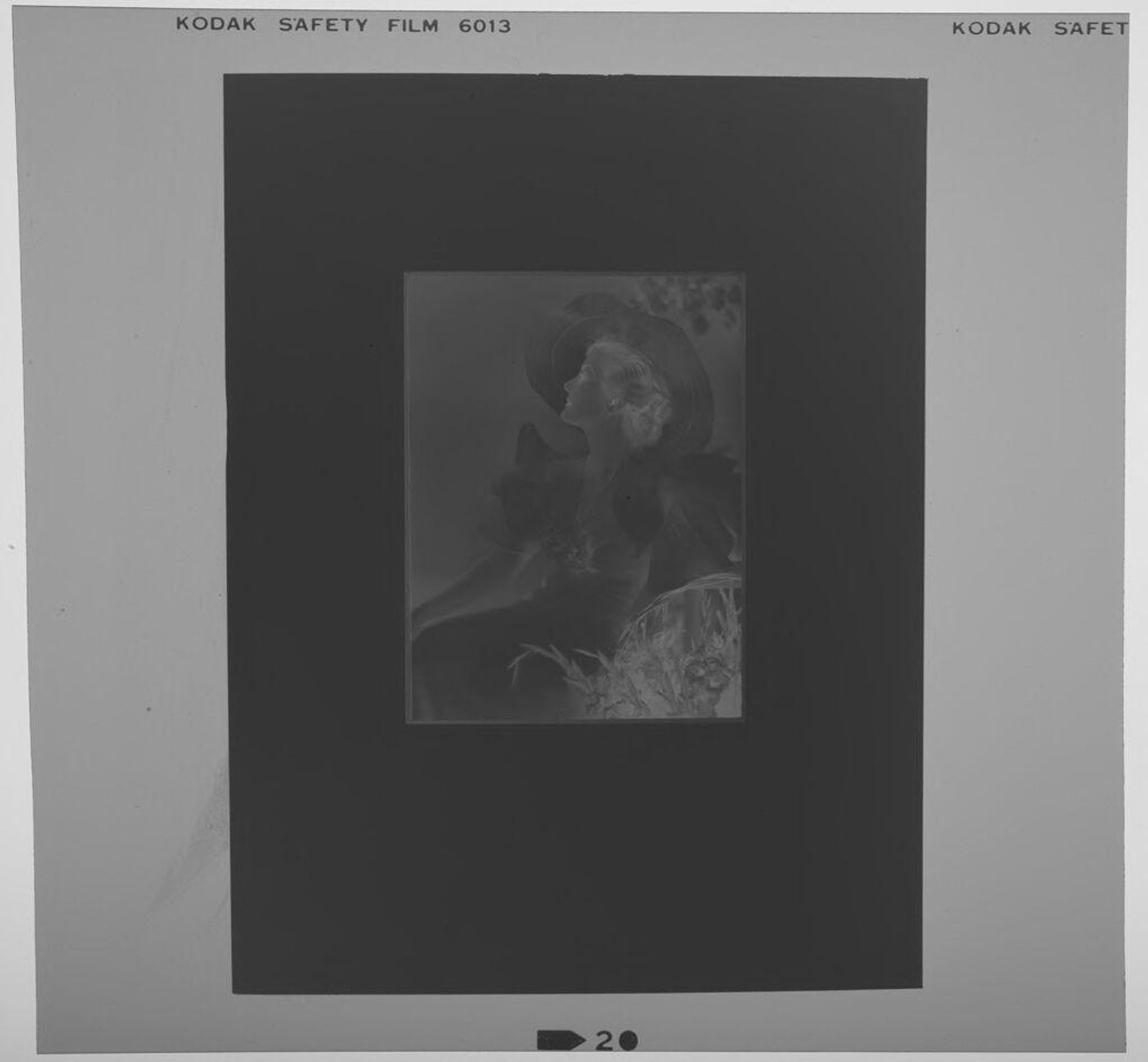 Untitled (photograph of woman seated by flowers in large hat by Paul Gittings