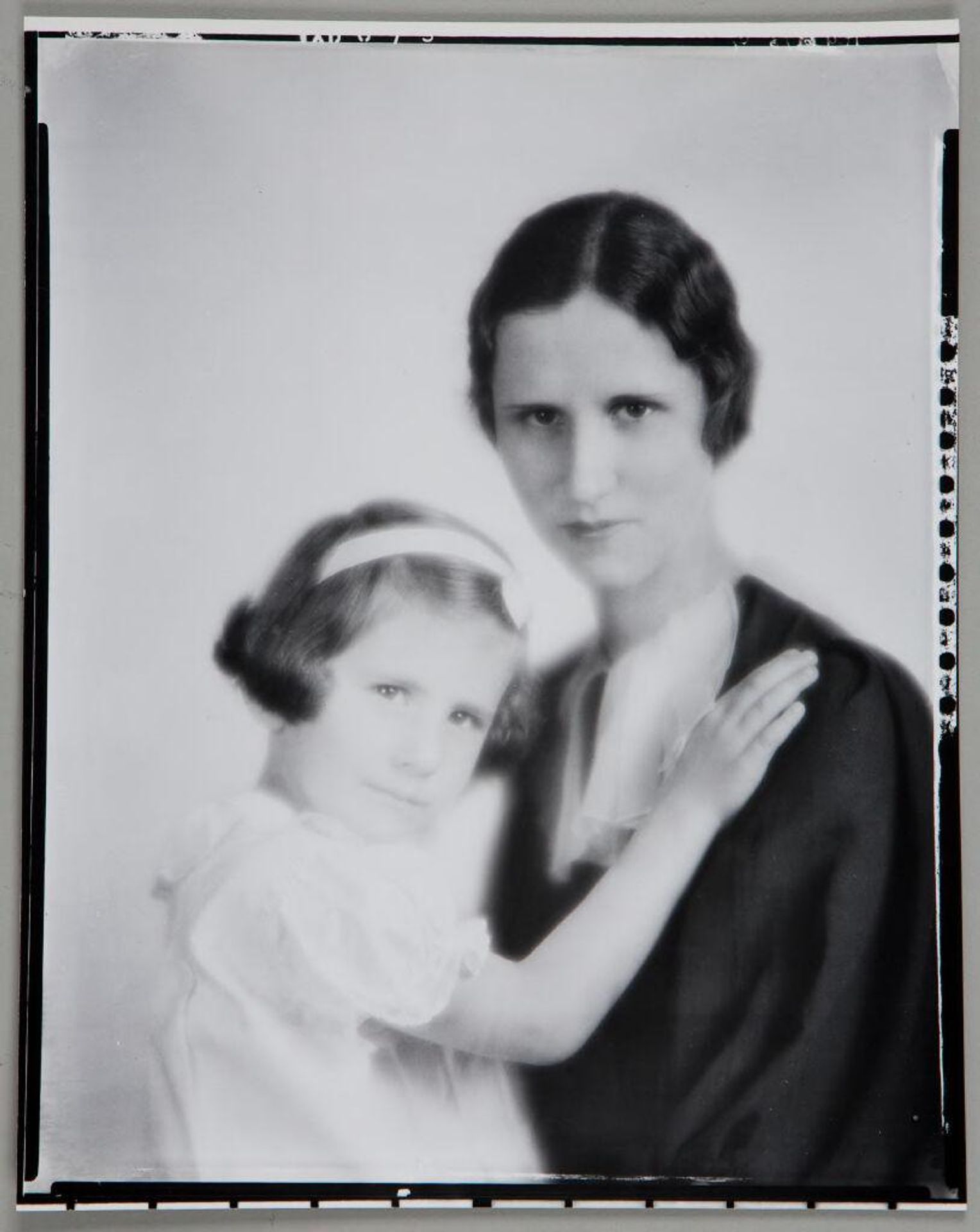 Untitled (woman seated with young girl, girl's hand on her shoulder) by Paul Gittings