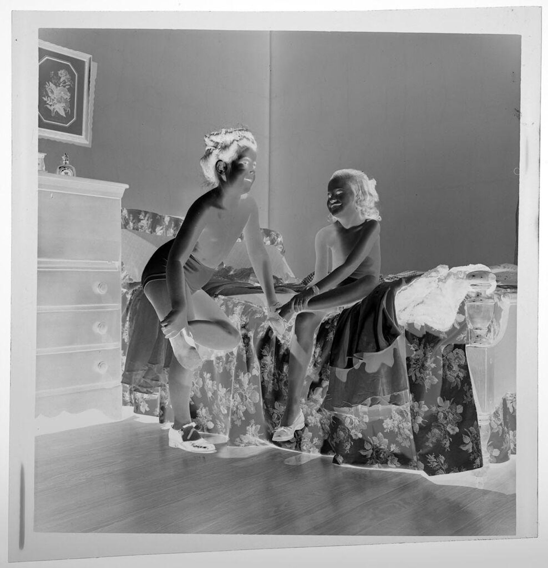 Untitled (two girls playing "dress up" next to bed) by Jack Gould