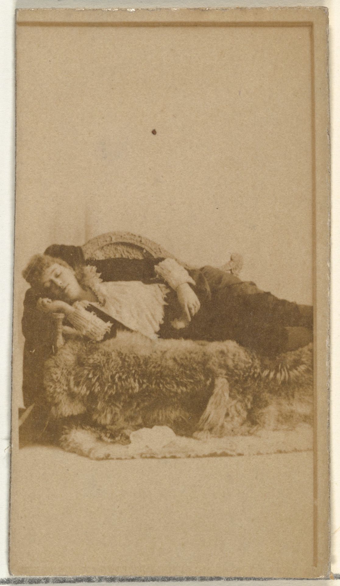 [Actress reclining on furs], from the Actors and Actresses series (N145-8) issued by Duke Sons & Co. to promote Duke Cigarettes by W. Duke, Sons & Co.