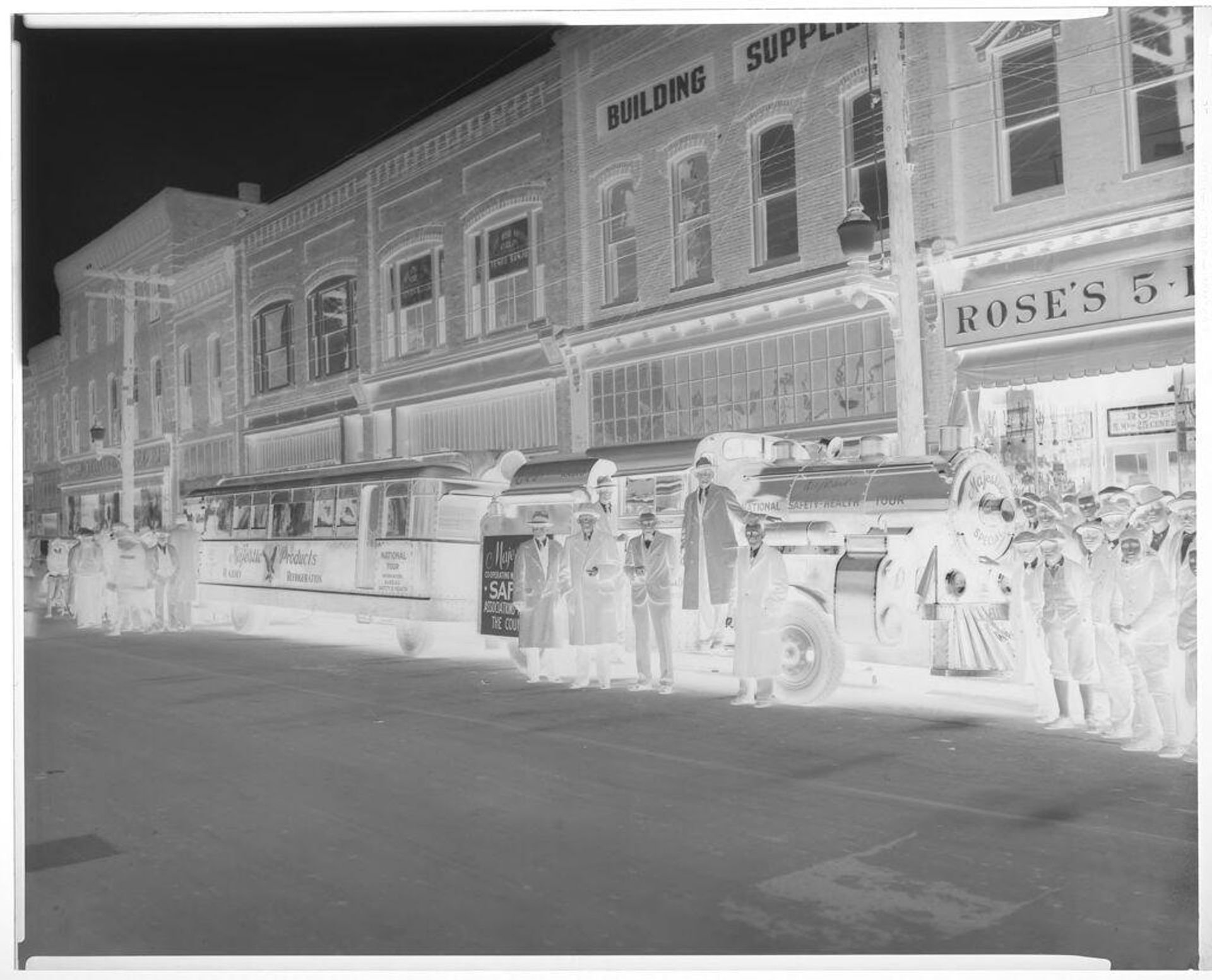 Untitled (crowd around train and bus on street) by Hamblin Studio