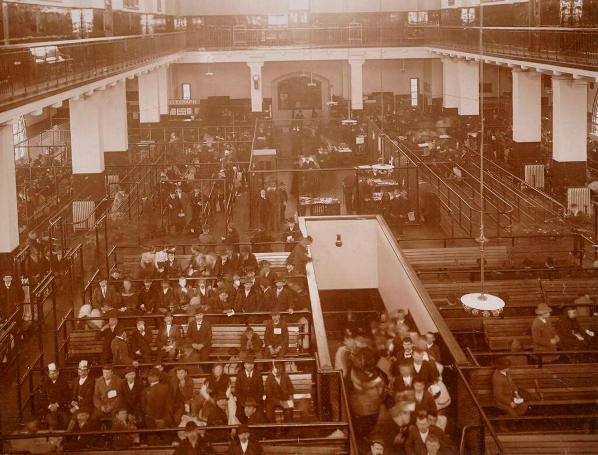 Races, Immigration: United States. New York. New York City. Immigrant Station: Regulation of Immigration at the Port of Entry. United States Immigrant Station, New York City: View of main floor. Immigrants awaiting further inspection. by J. H. Adams