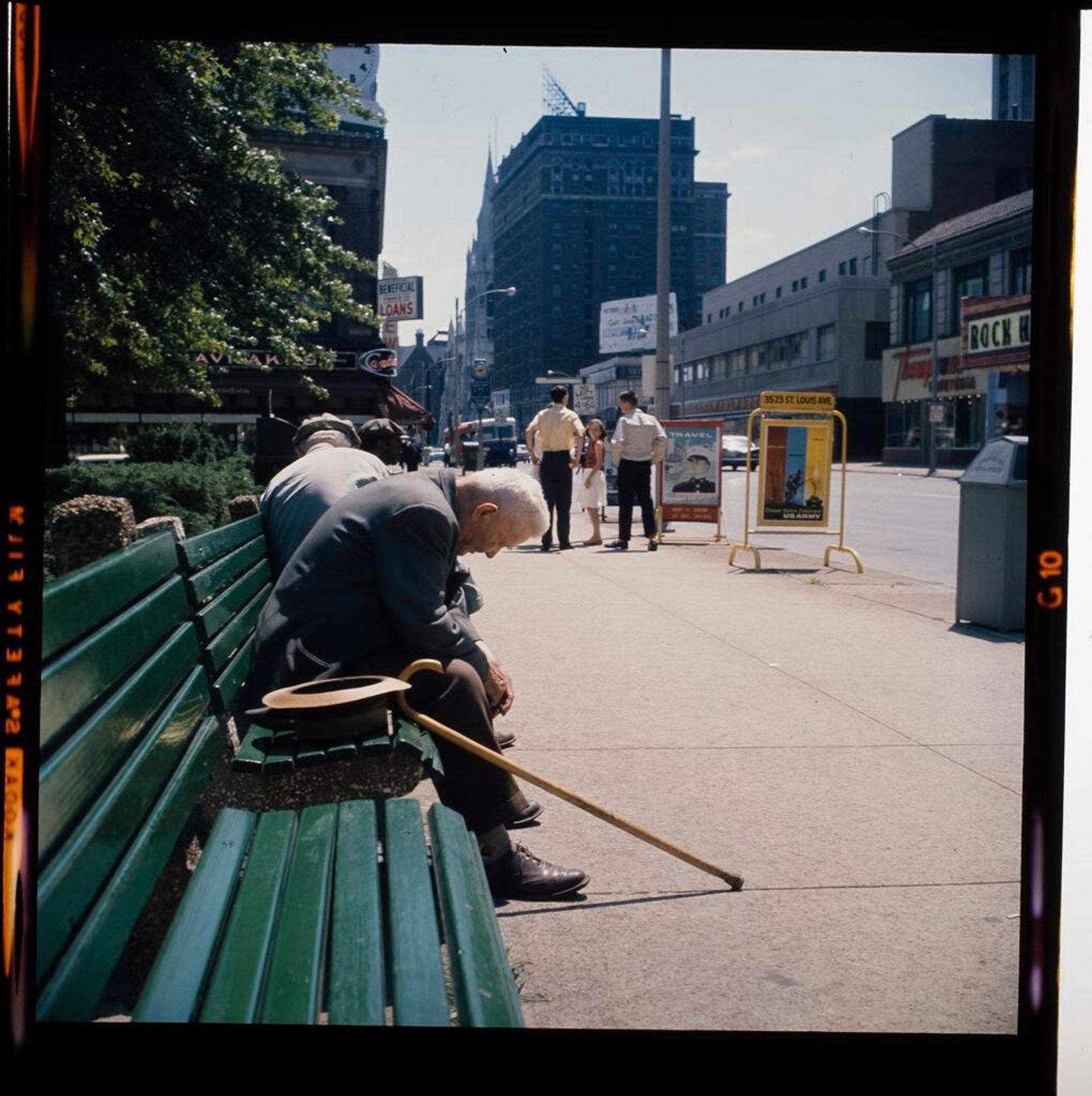 Untitled (elderly man sitting on city bench, head down) by Jack Gould