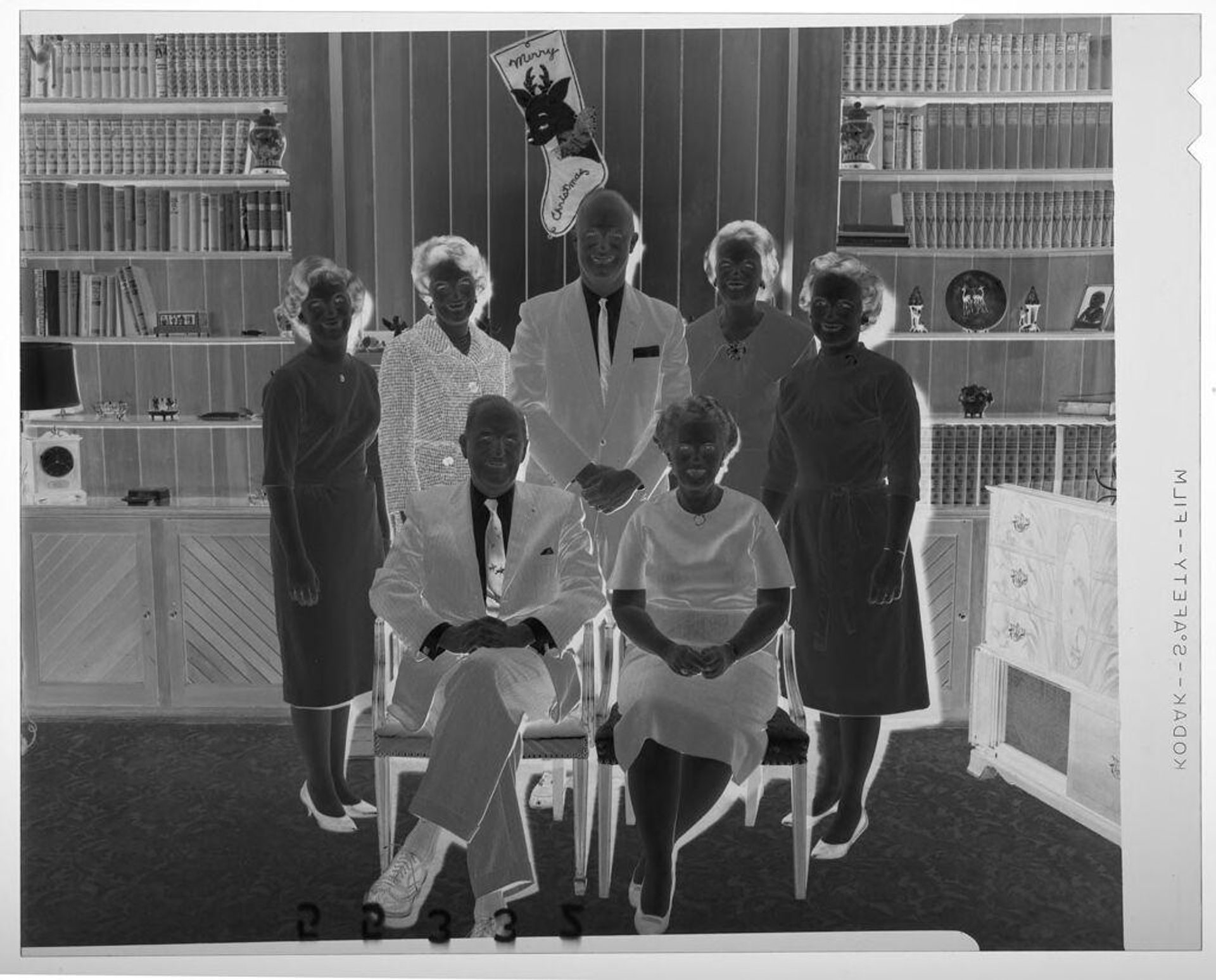 Untitled (seven members of family posed in front of mantel at Christmas gathering) by Martin Schweig