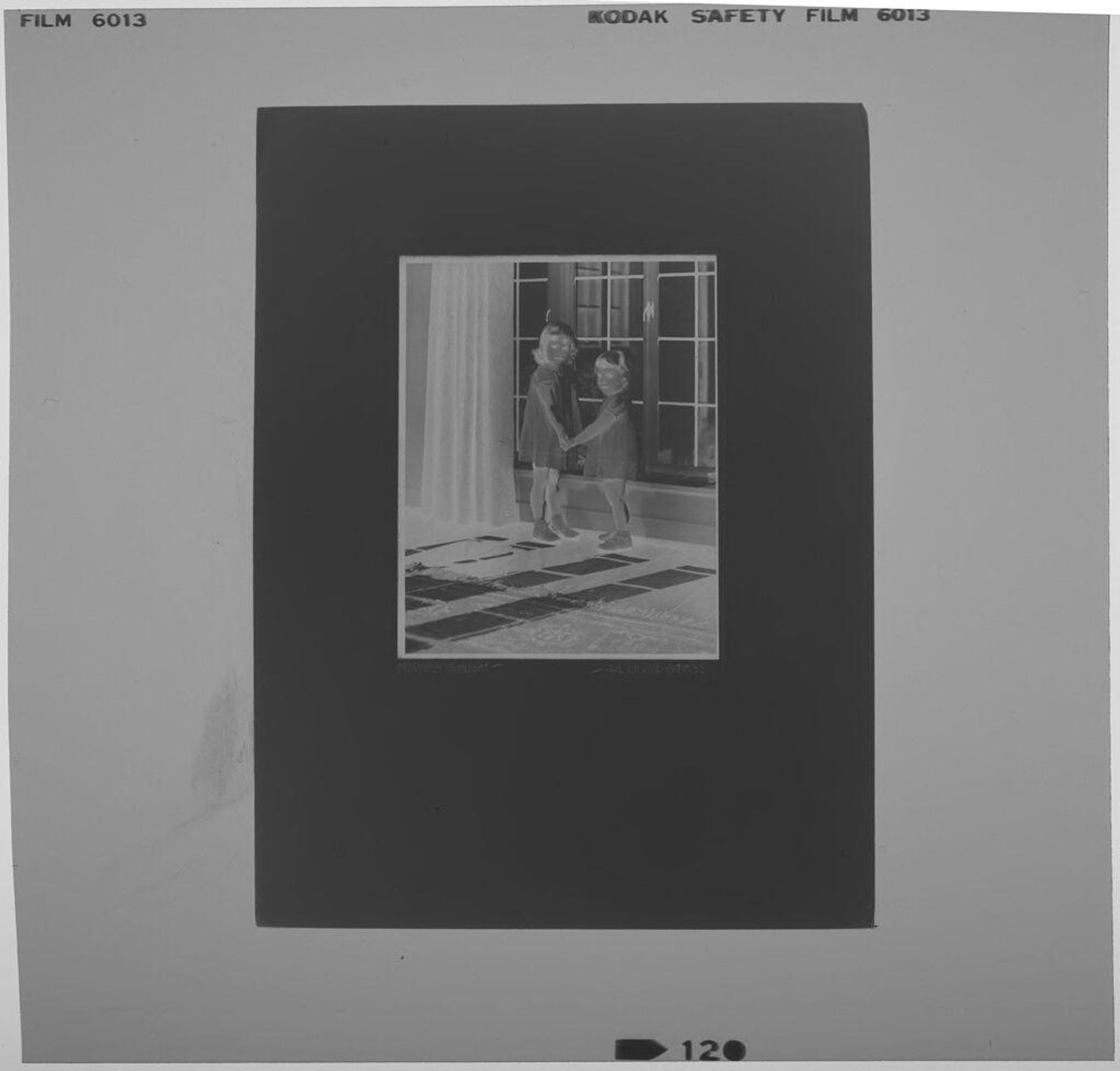 Untitled (photograph of "Morning Sunlight": two little girls holding hands in front of glass doors) by Paul Gittings