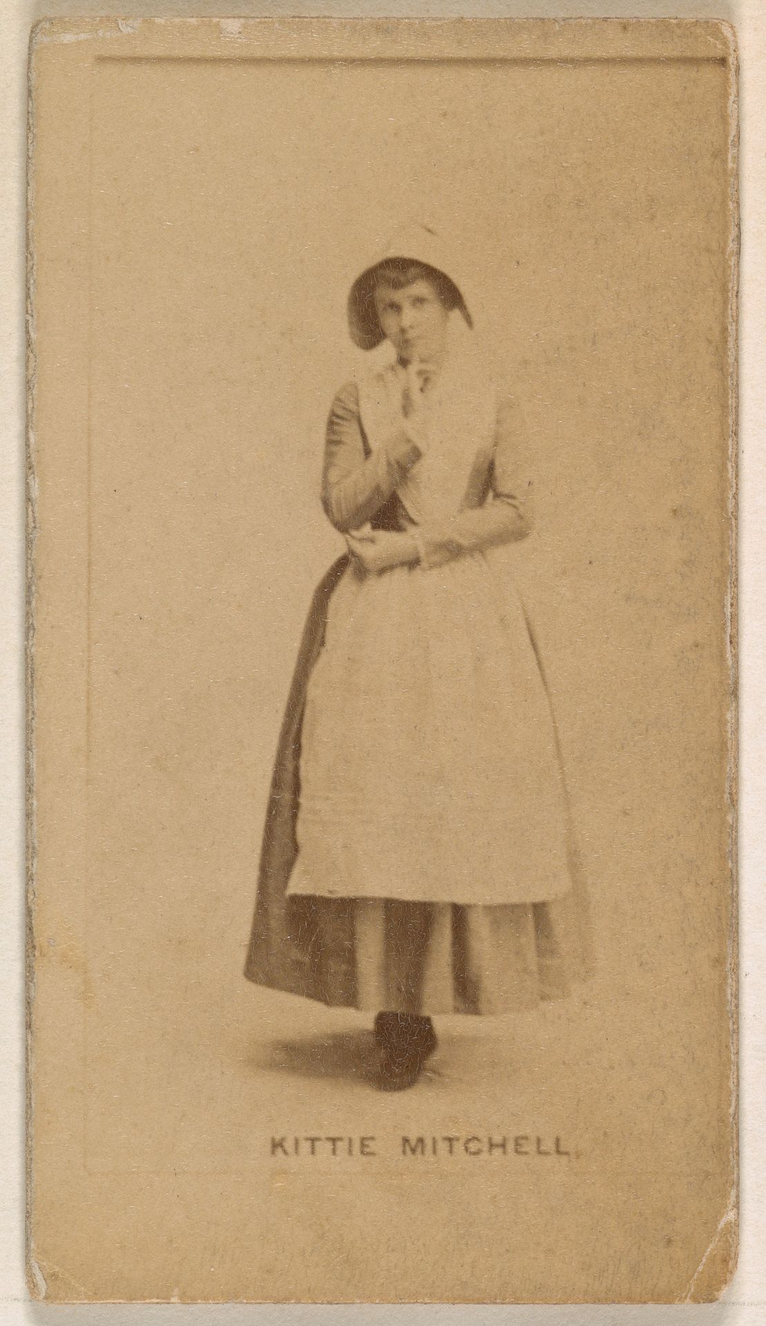 Kittie Mitchell, from the Actresses series (N245) issued by Kinney Brothers to promote Sweet Caporal Cigarettes by Kinney Brothers Tobacco Company