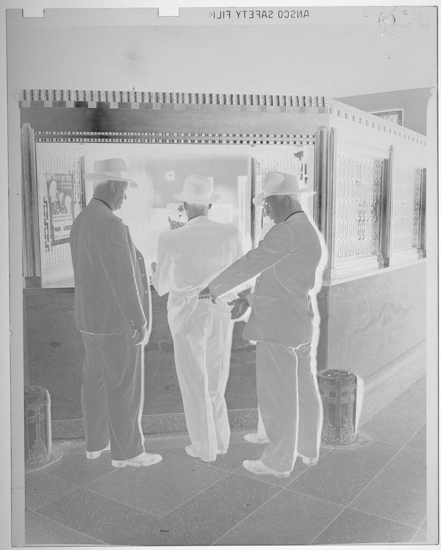Untitled (three men in police department, one man's hands in another man's pants) by Jack Gould