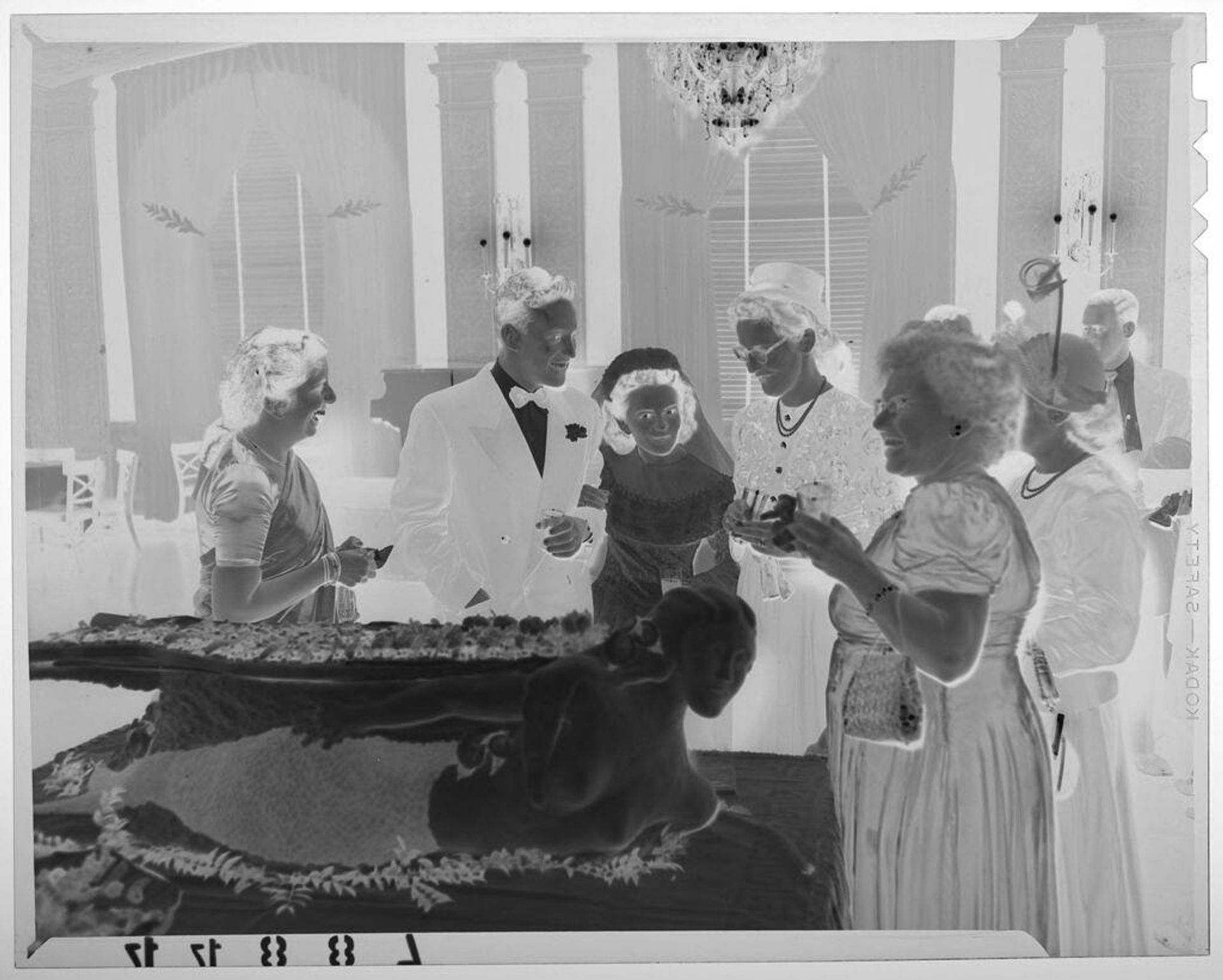 Untitled (bride and groom chatting with guests next to mermaid buffet platter) by Martin Schweig