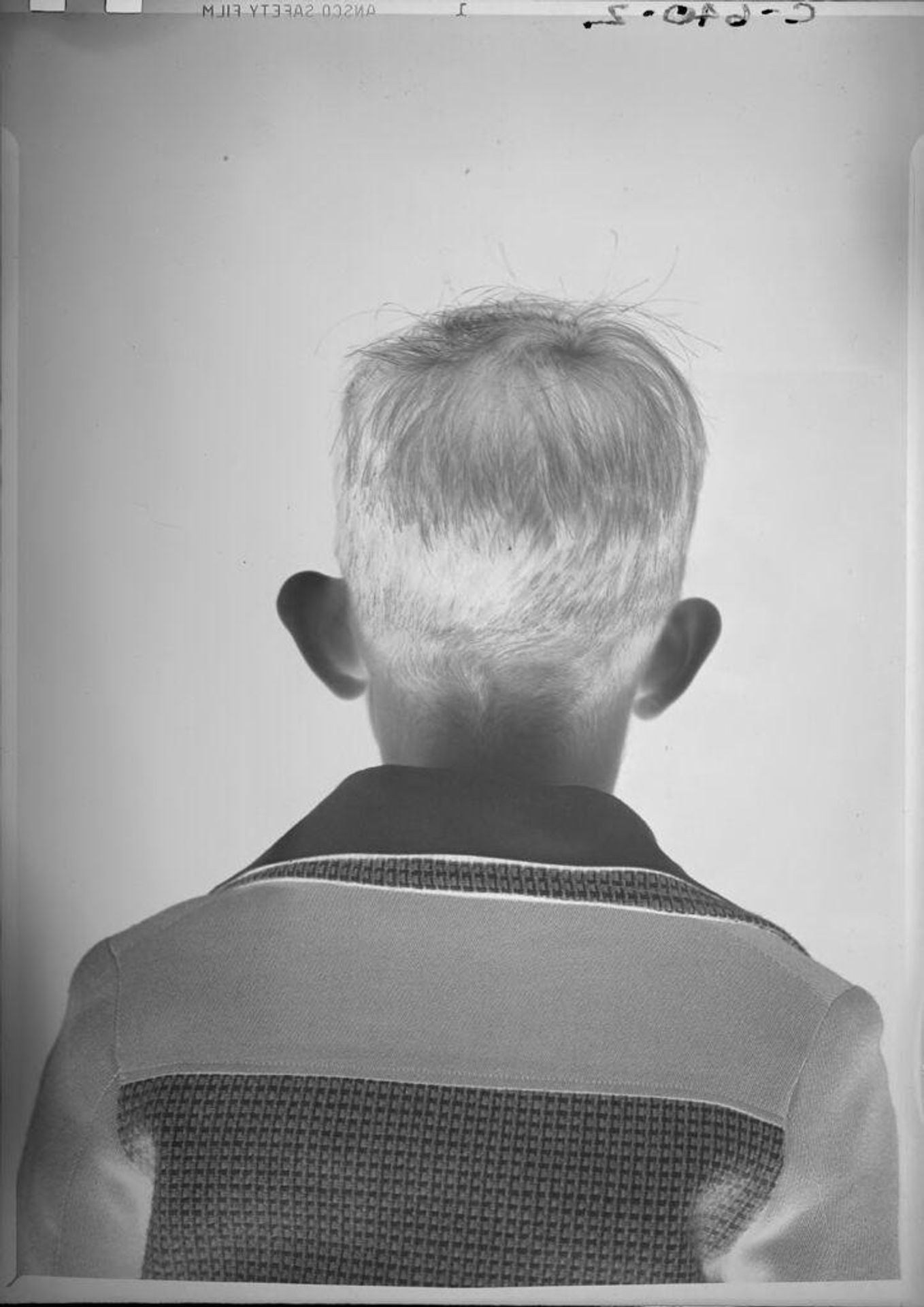 Untitled (back of boy's head) by Robert Burian