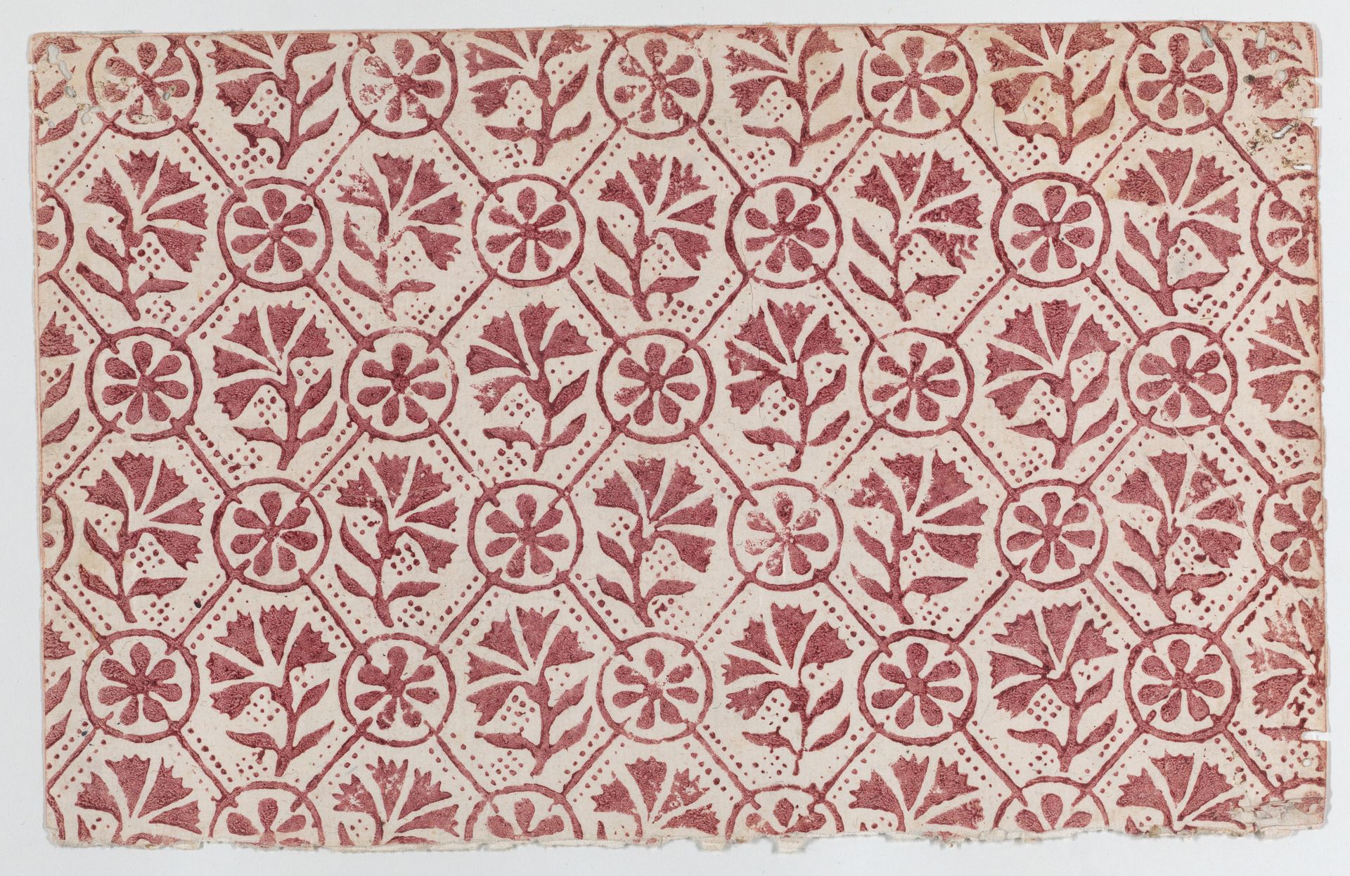 Sheet with overall red geometric and floral pattern by Anonymous